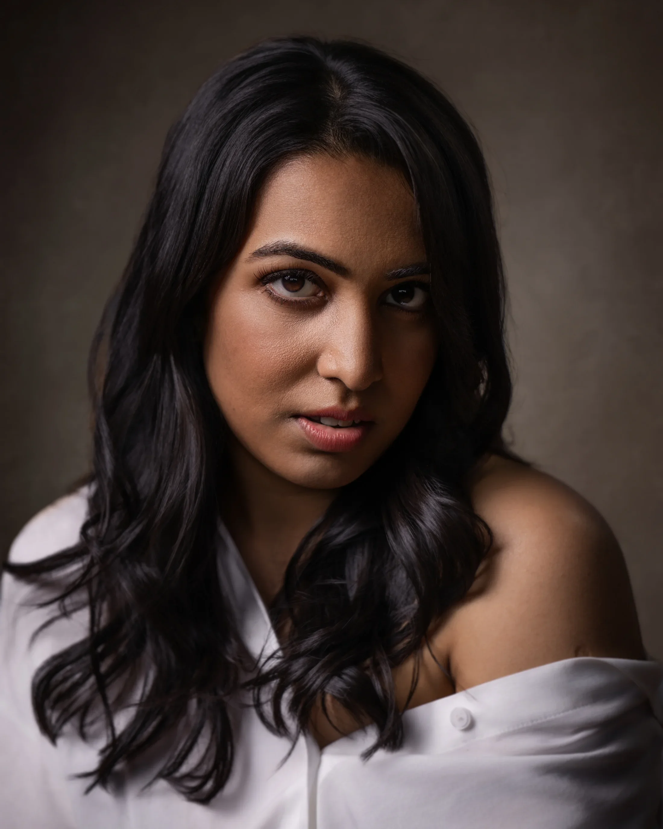 Editorial portrait of Toronto Lifestyle Photographer Pooja Maheshwari of Lenses for Love, wearing an off-the-shoulder white blouse.