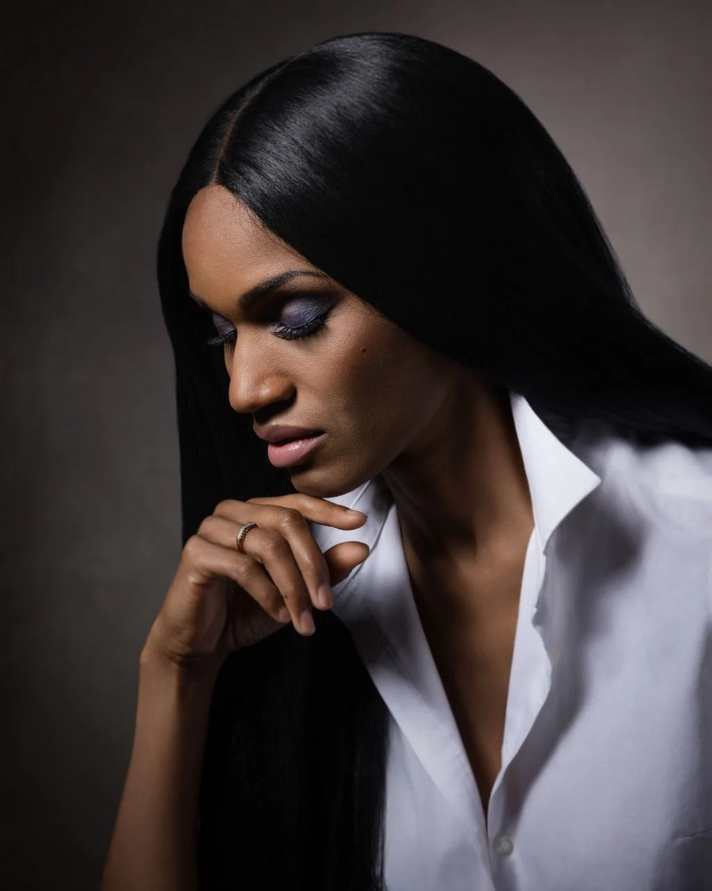 Close up colour editorial portrait of actor Dominique Brownes in a contemplative pose.