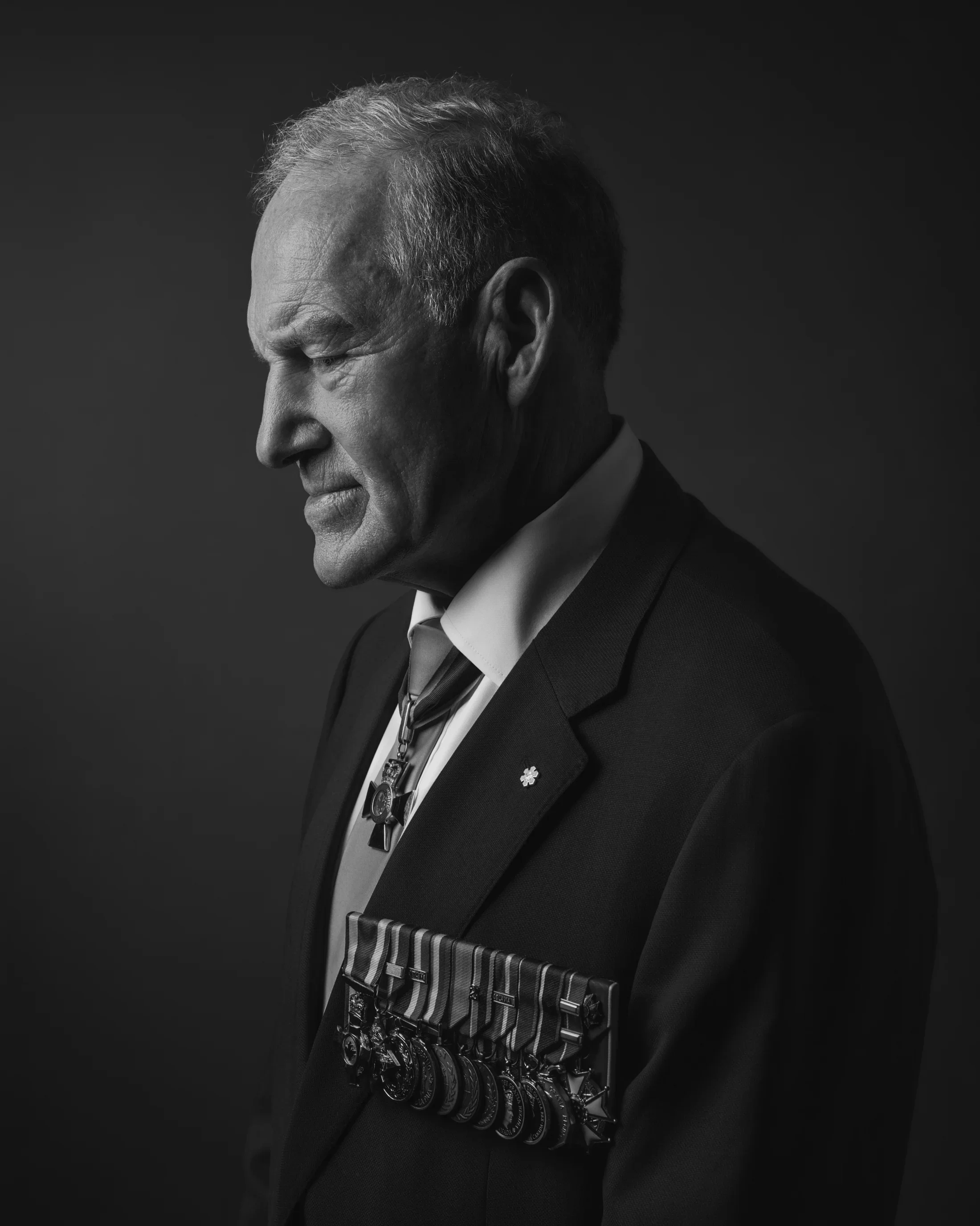Powerful black and white portrait of General Walt Natynczyk, in a contemplative profile pose.