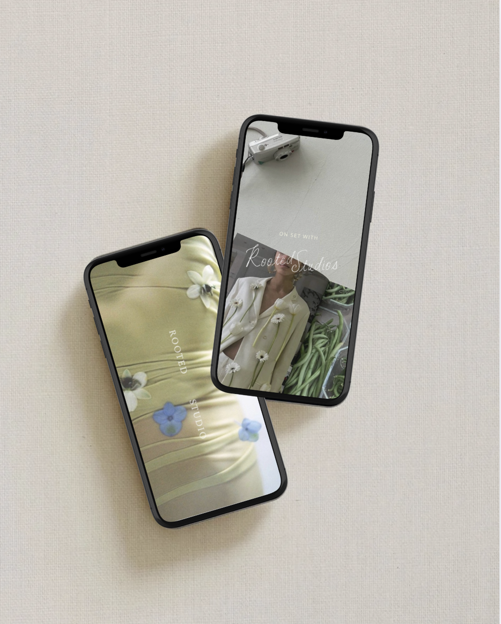 Two smartphones on a light-colored surface displaying images and text related to Rooted Studios, with one phone showing a person in a yellow outfit with flowers and the other showing a person in white with green plants.