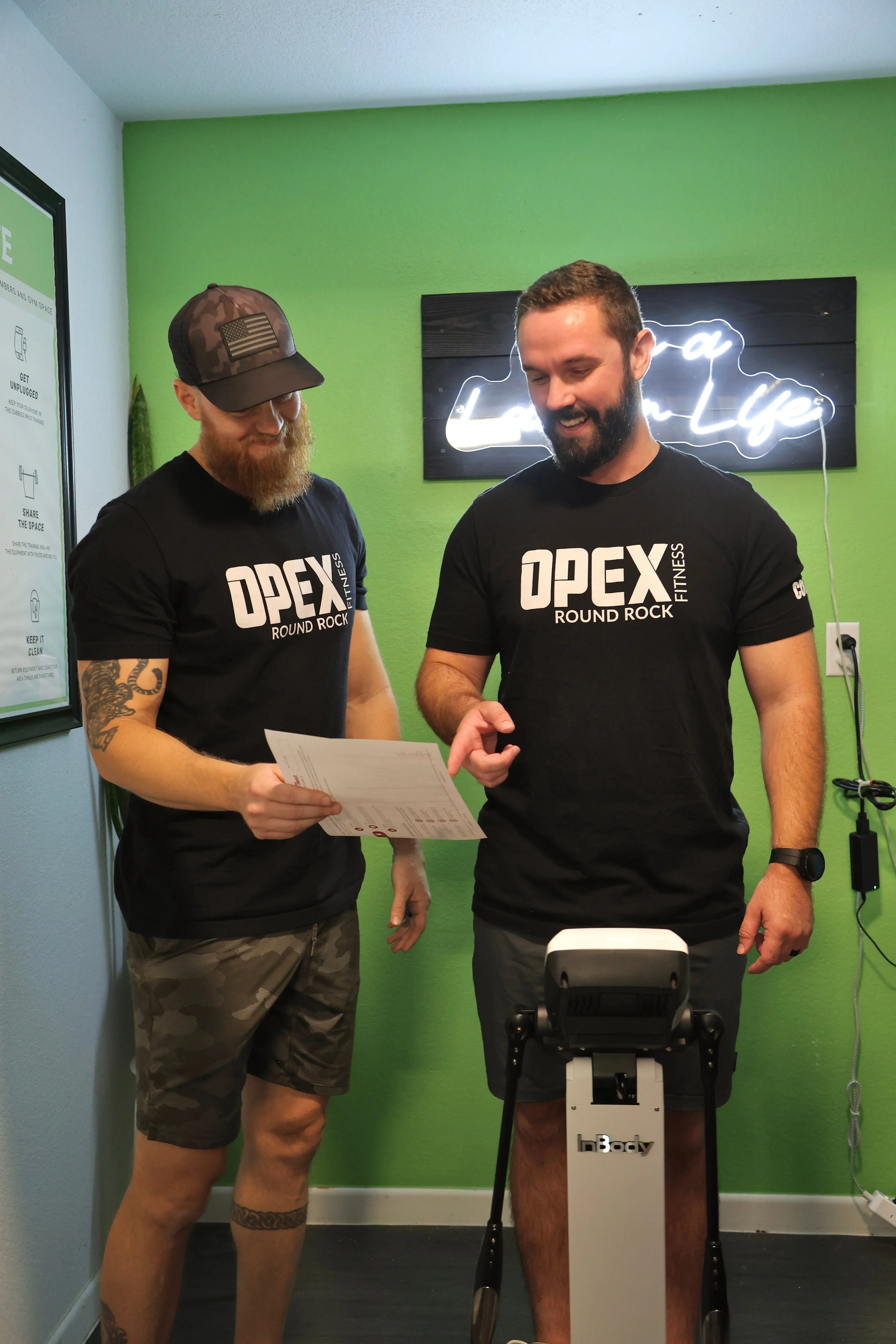 Coach PJ overseeing his client on the InBody machine.