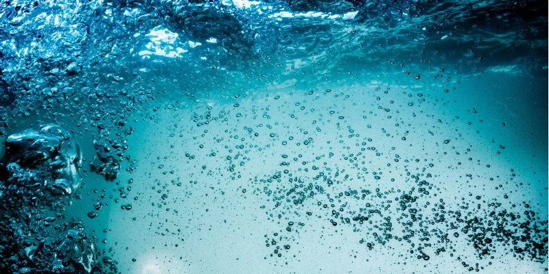 Underwater view with air bubbles rising toward the surface.