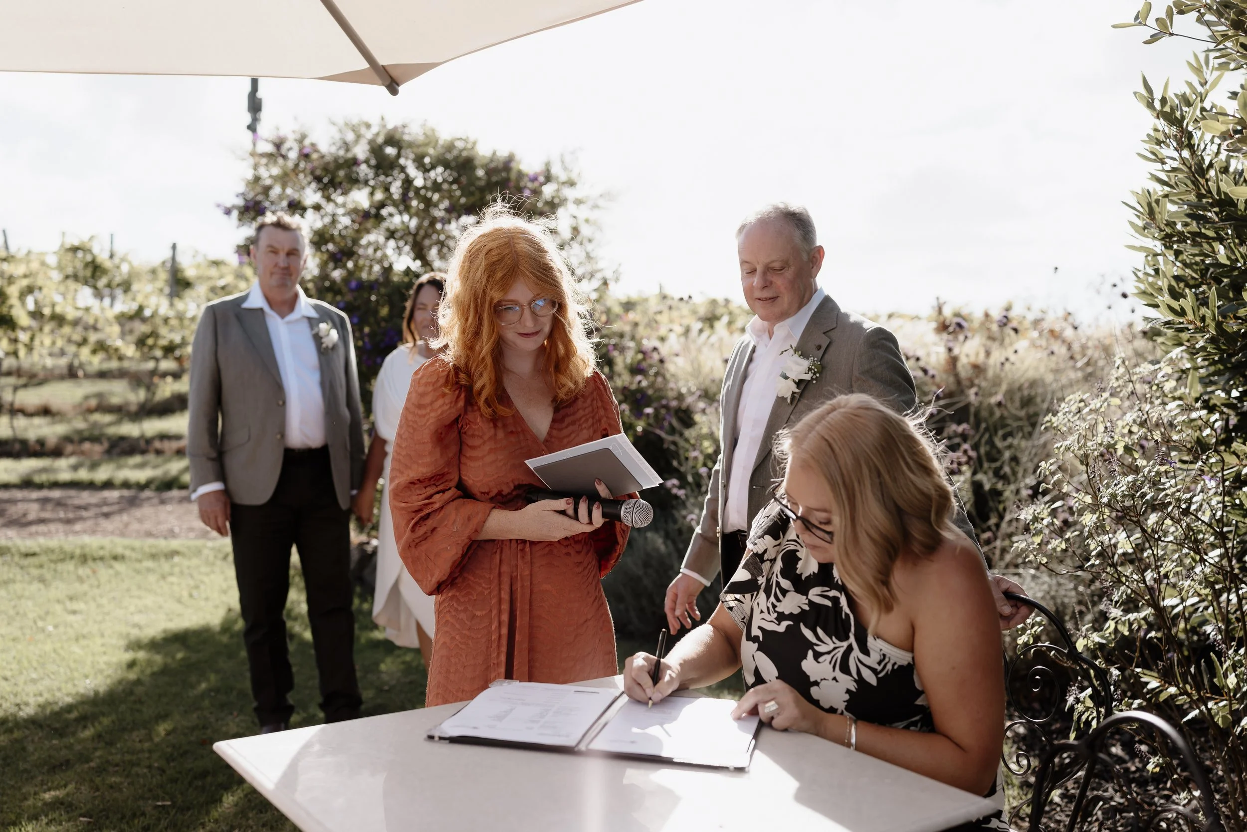 waiheke wedding celebrant overseeing signing of the marriage licence at Tantalus Estate