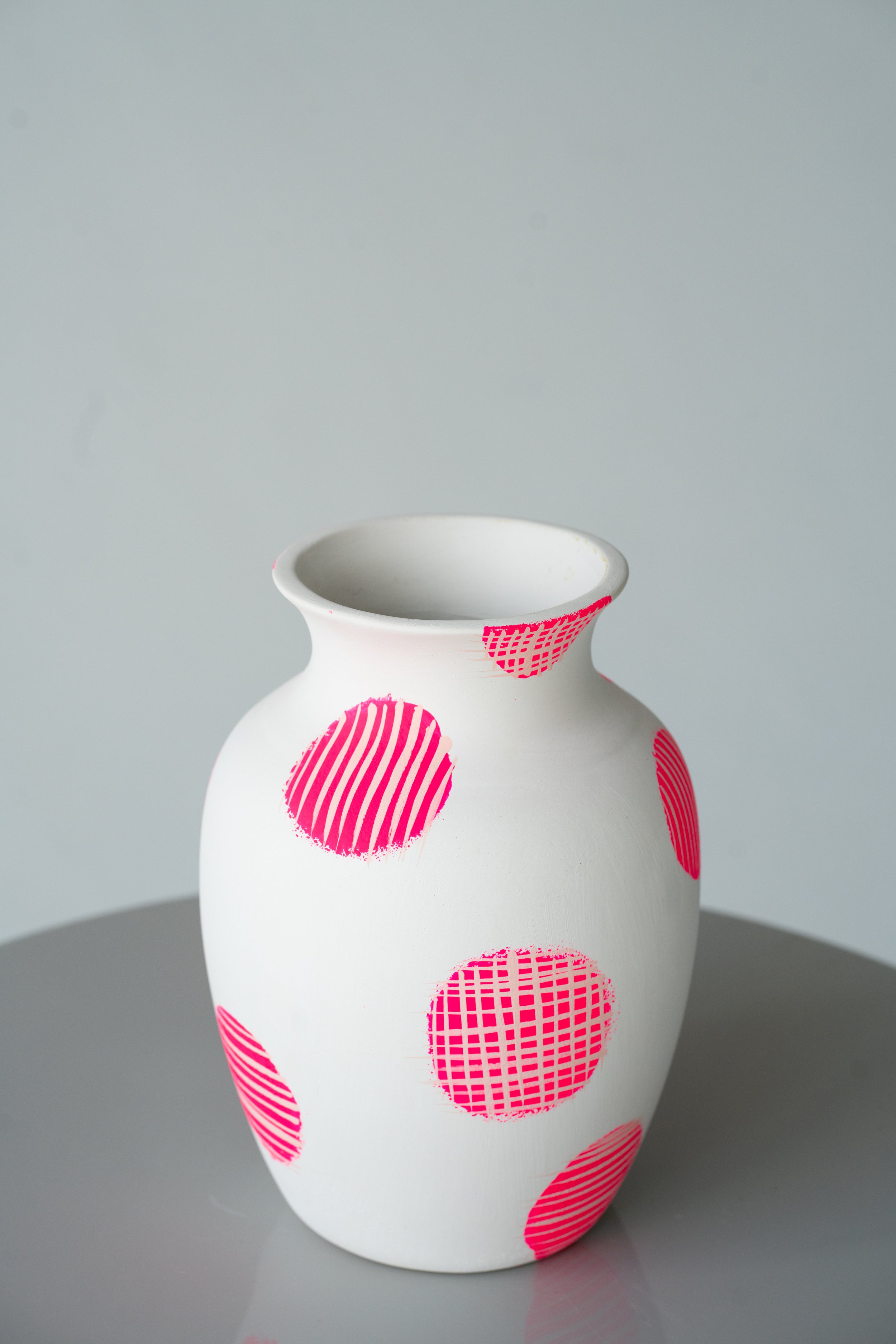White vase with neon circle