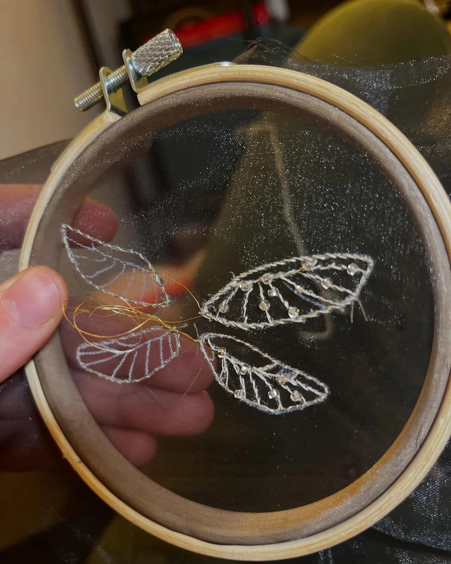 Process for making the beetle

Images:
1. Wire framed wings on organza 
2. Tread wrap wire for the antennae 
3. Lay out shells and body and couch down foam or felt for dimension
4. Fill in body and wing shells
5. Remove everything from the frames and
