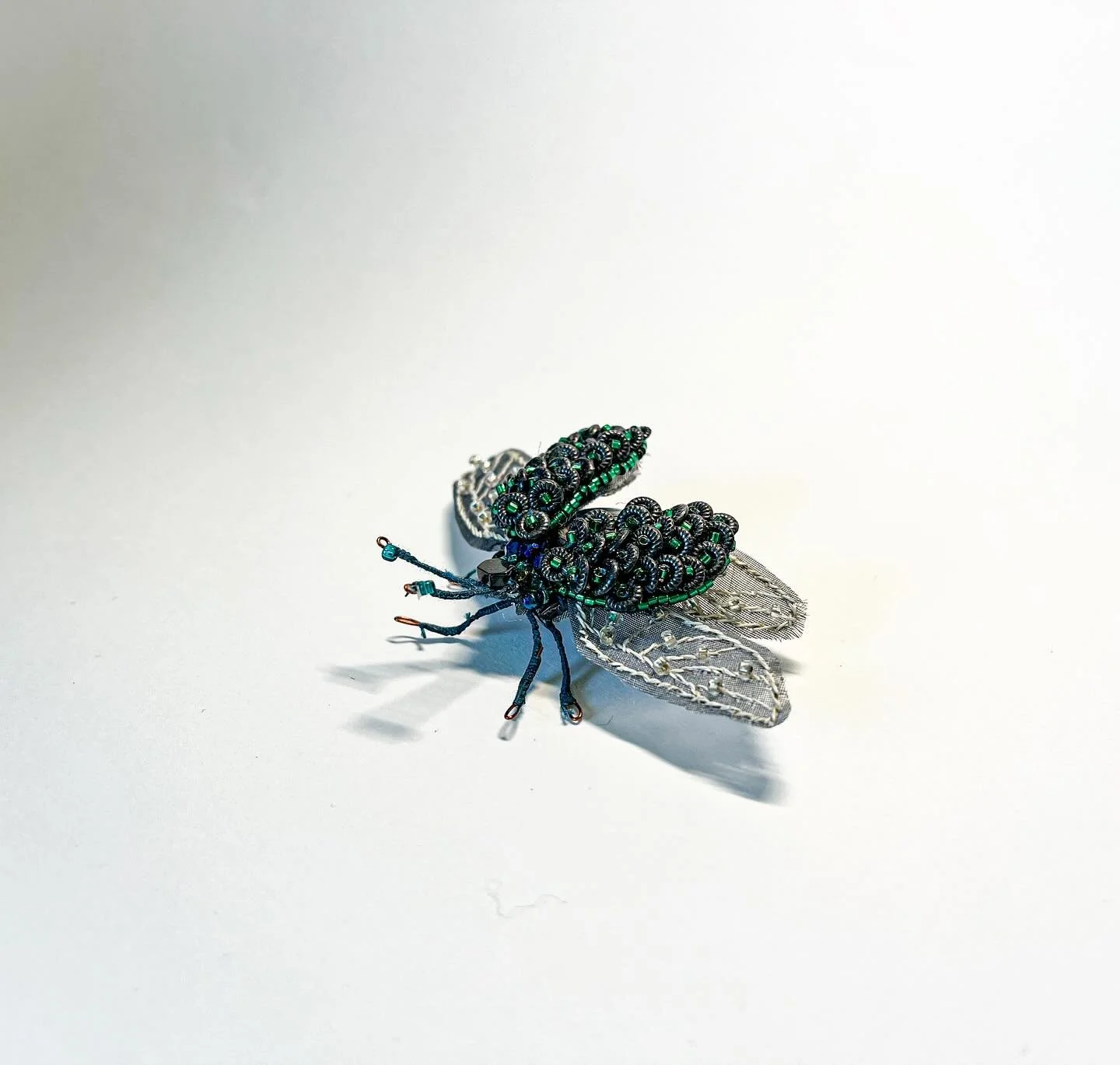 A return to beading

A couple months ago I made a return to creating beaded insects with this little guy. Each piece of him was hand beaded separately within a wire frame and then assembled together to make his final form which is about 1.5&rdquo; in