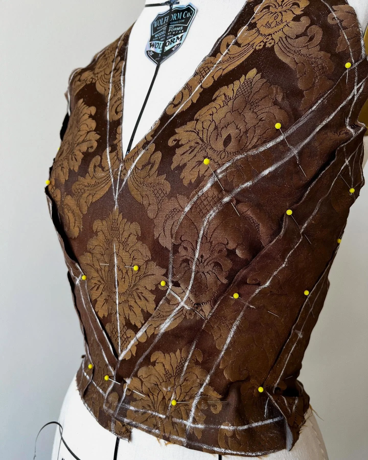 WIP on a draped bodice - also first venture in really paying attention to pattern matching! 

These are the cut pieces pinned to the dress form so that I can ensure the motif remains intact as much as possible. Next is lots of hand basting 

#costume