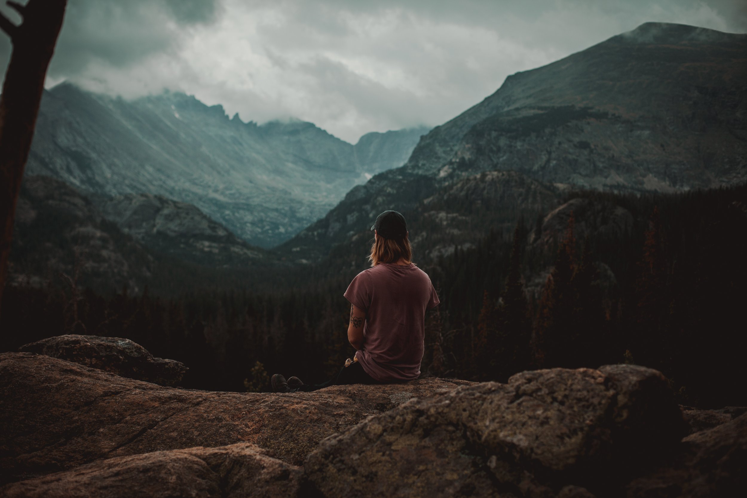 Keegan sitting on a mountain