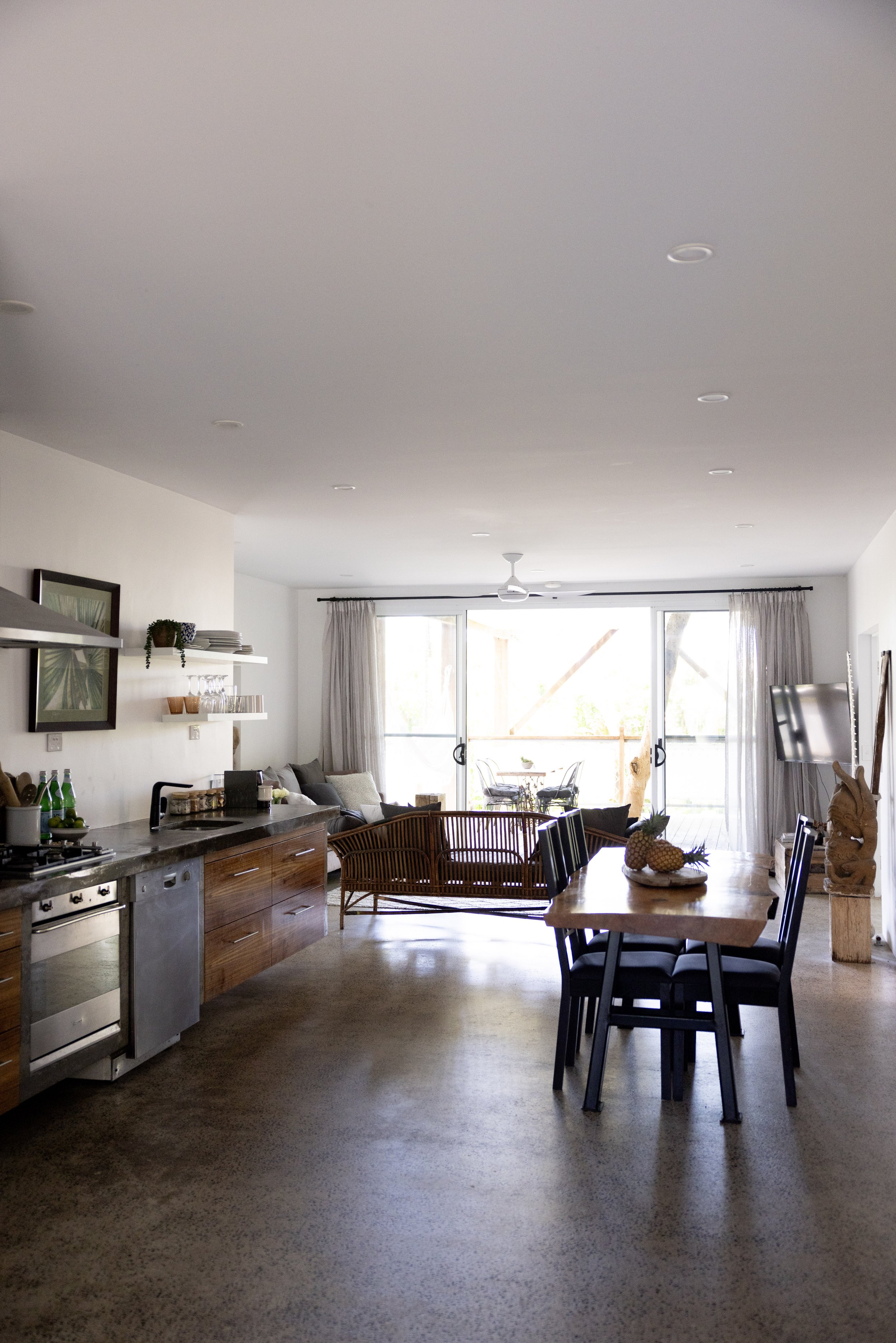 Spacious open-plan living and dining area with polished concrete floors at Haven Tropicana.