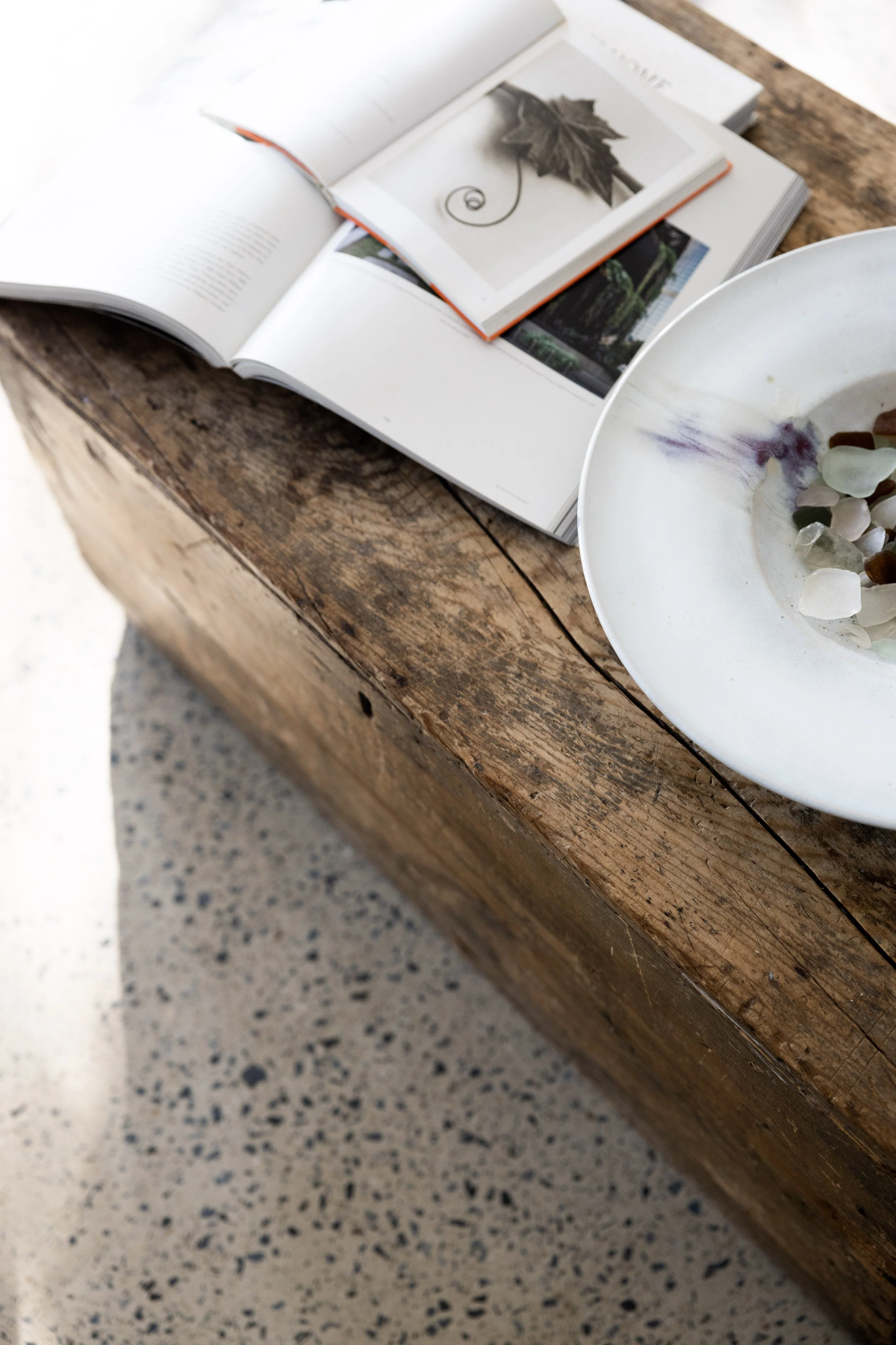 Tropicana living space with handcrafted timber furnishings, polished concrete floors and soft natural light overlooking tropical gardens at The Beach Havens, Emerald Beach NSW