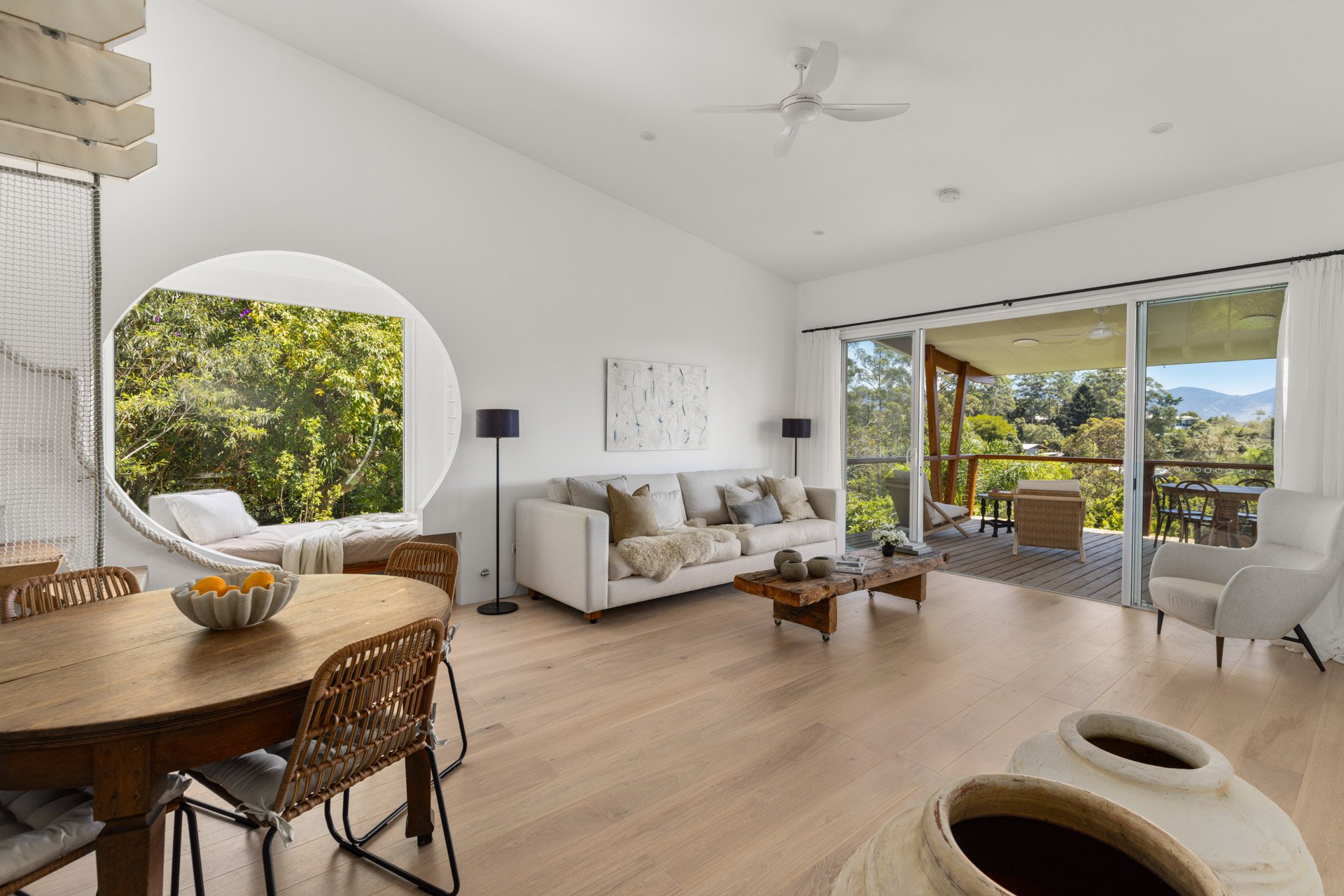 Light-filled open-plan living, beautiful timber floors, floating stairs and circular windows.