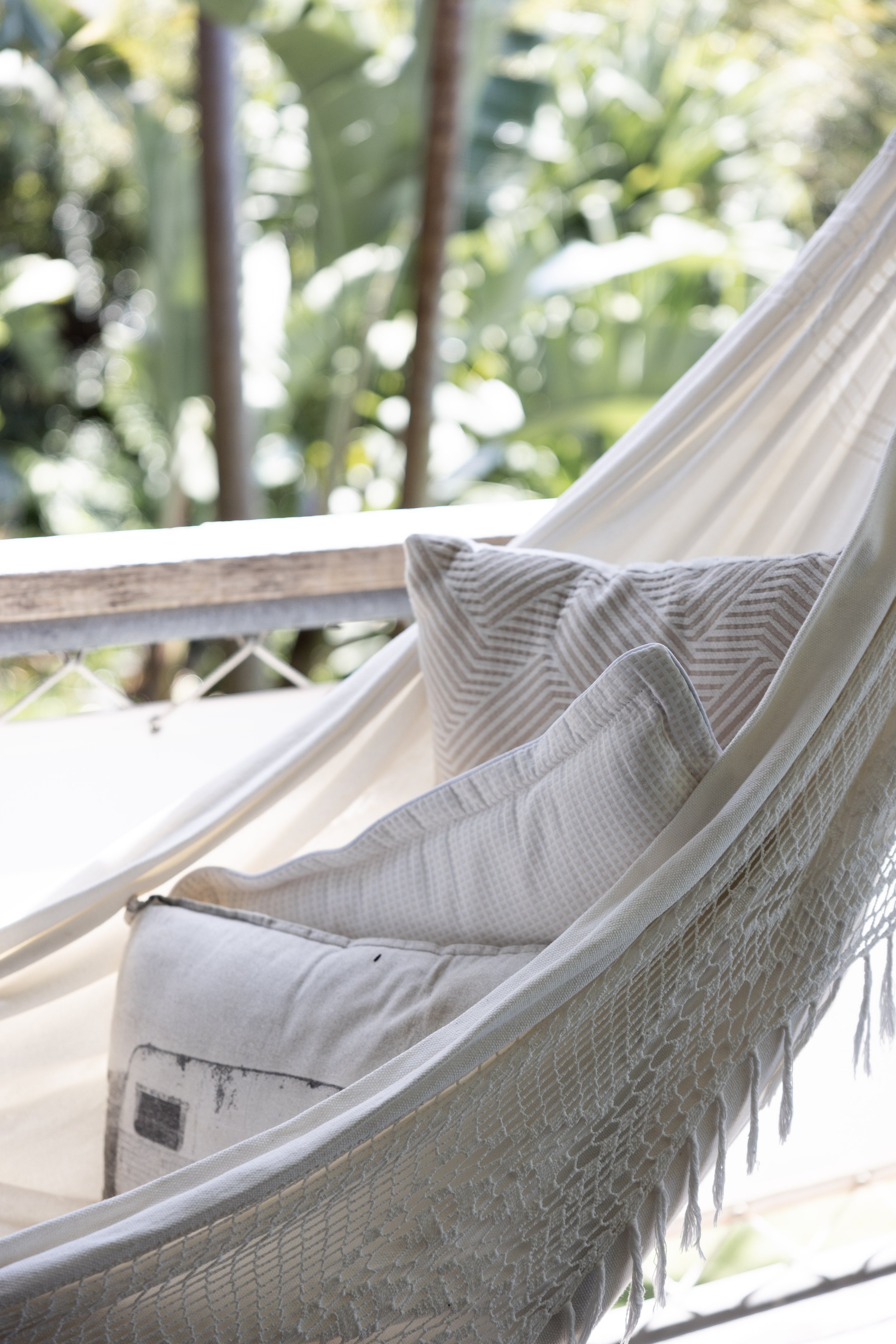 Relaxing double Brazilian hammock on Haven Tropicana’s deck, surrounded by lush tropical greenery.