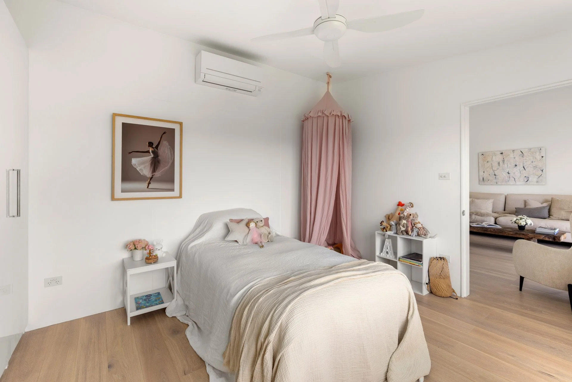 A light-filled, beautifully styled king single bedroom with a peaceful garden outlook.