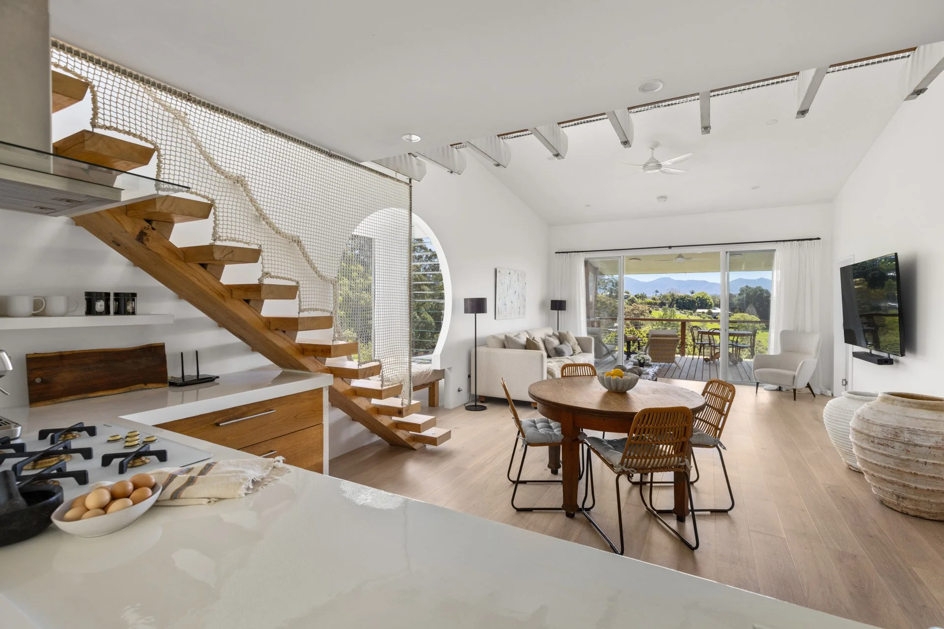 Beautifully designed, light-filled open-plan living with soaring ceilings, distinctive architectural features and sweeping views across the Bellinger Valley.