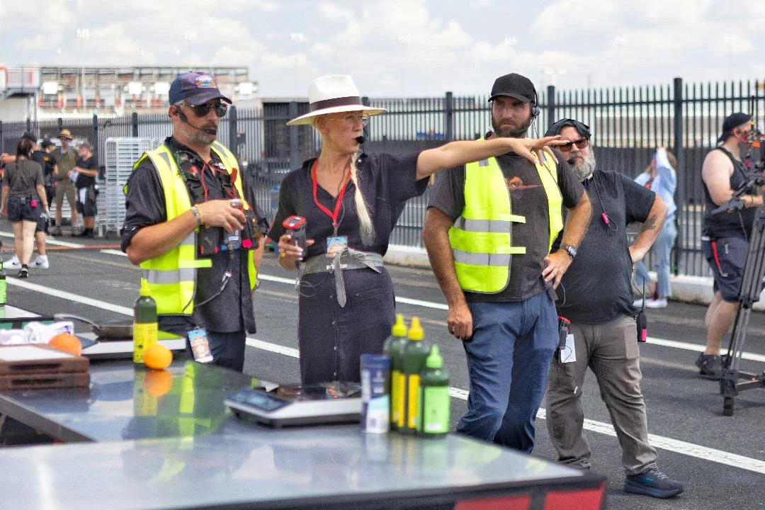 Anna directing with her AD team on Top Chef on a NASCAR race track