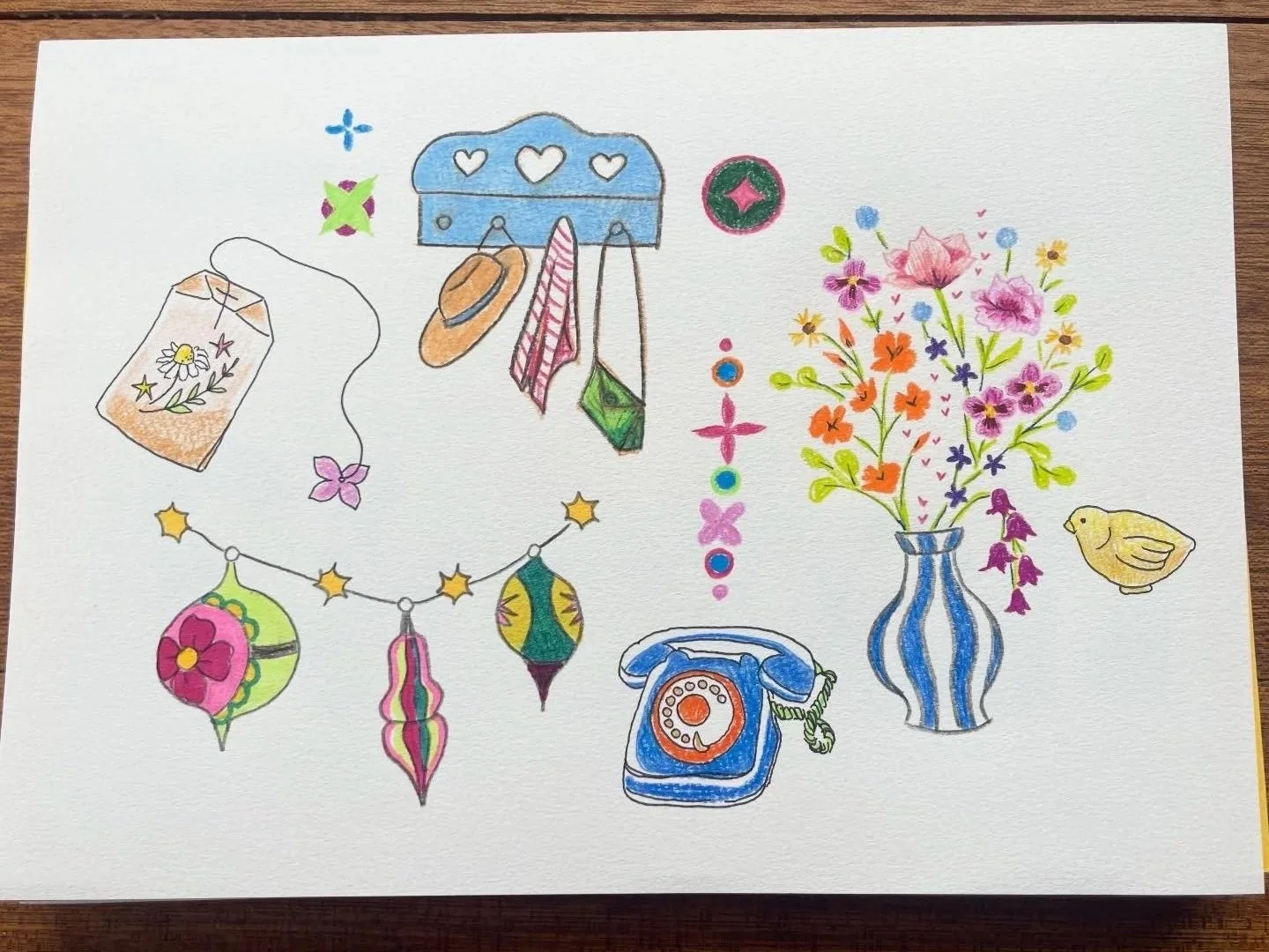 Colorful illustration of a blue wall hook with hats and clothes, a potted flower arrangement, a yellow bird, a string of decorative lanterns, and a blue rotary phone.