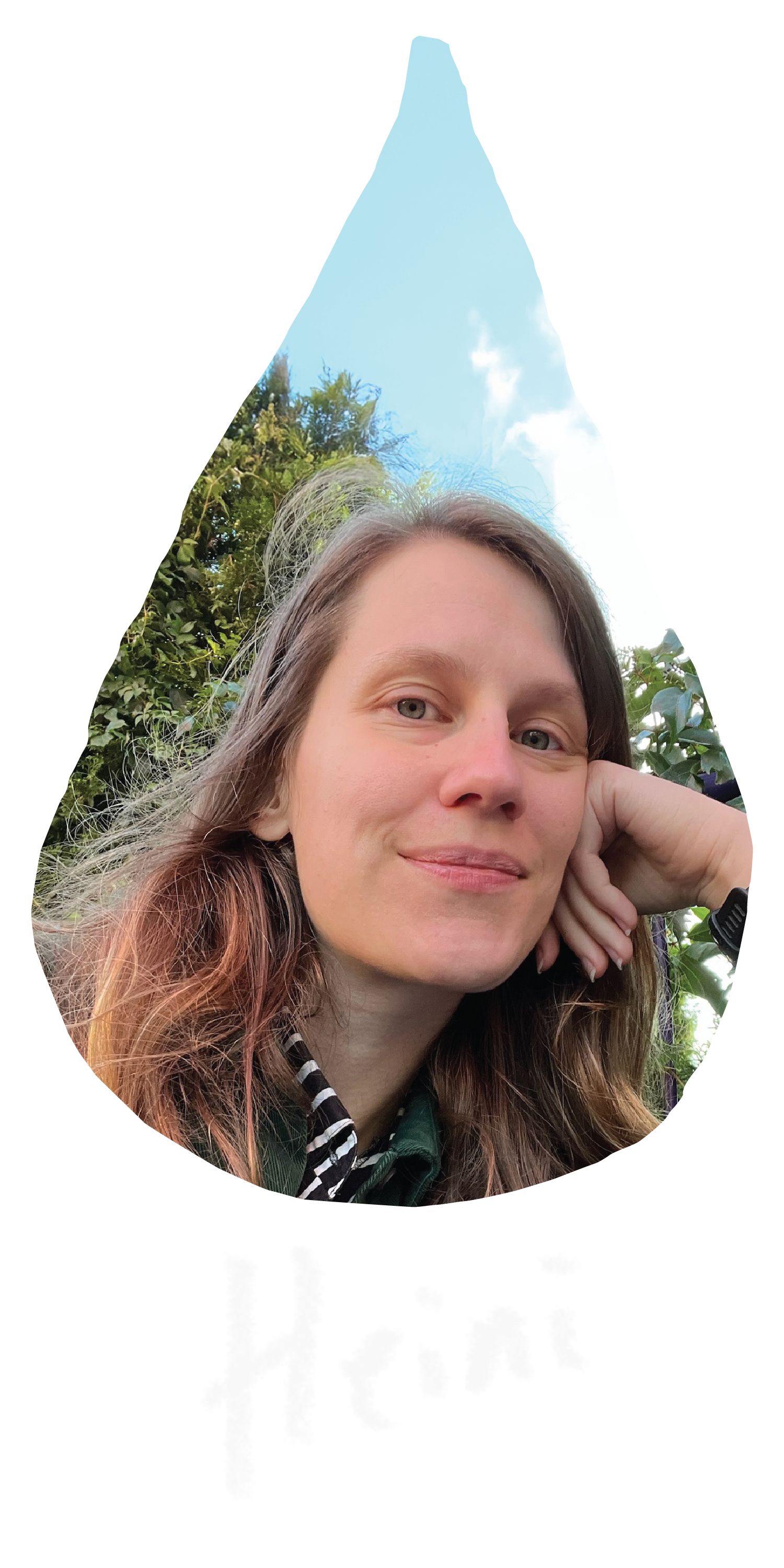 A raindrop shaped image of Heini, a white woman with long wavy brown hair wearing a green jacket and resting her head on her hand. She is outdoors, smiling and looking straight toward the camera.