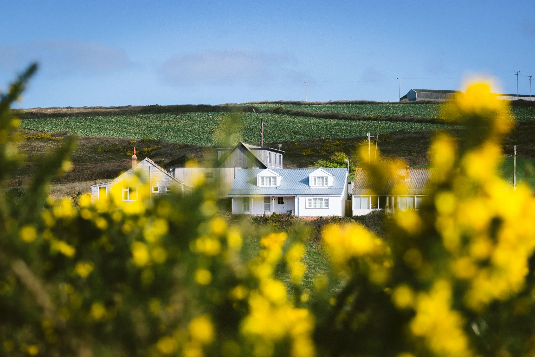Converted coastal home at Chapel Porth seen across the north Cornwall landscape near St Agnes, Elements Build