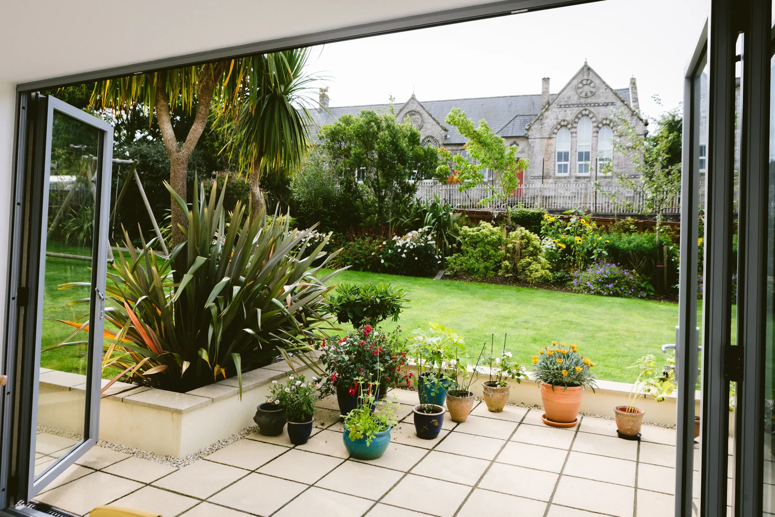garden-view-from-extension-bifold-doors-patio-cornwall.webp