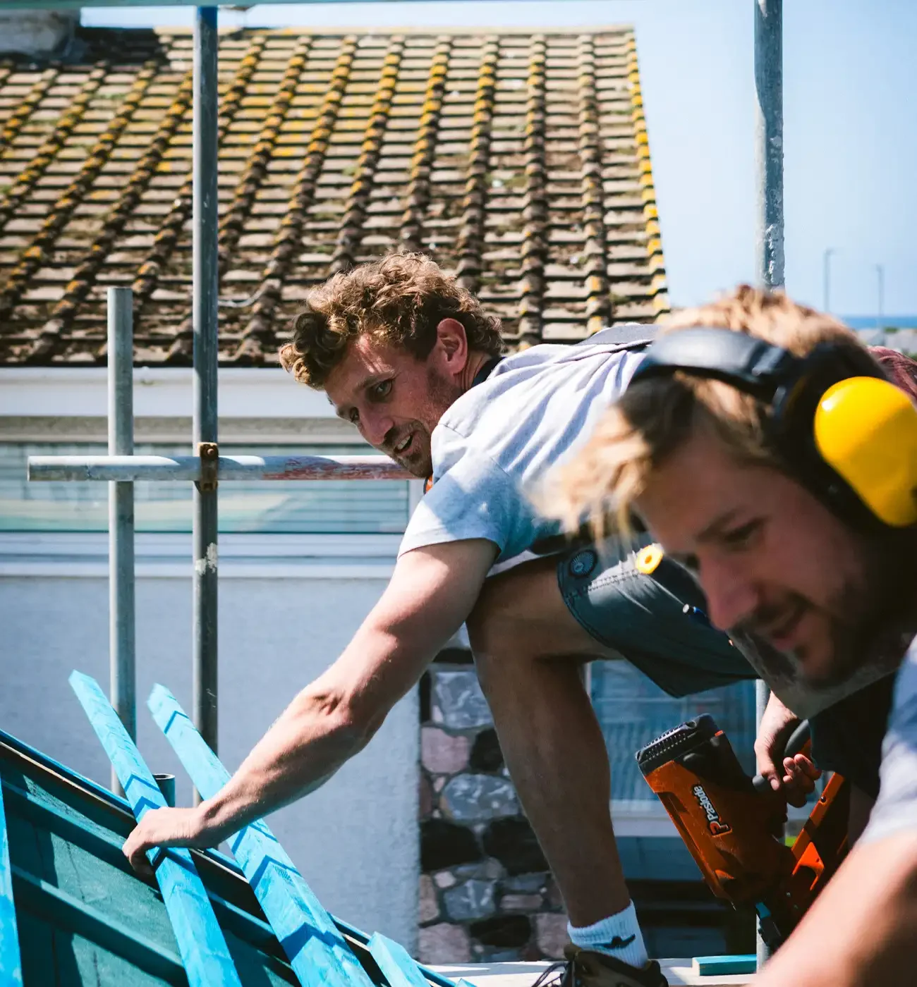 Elements Build team working on roof structure from scaffolding, Cornwall