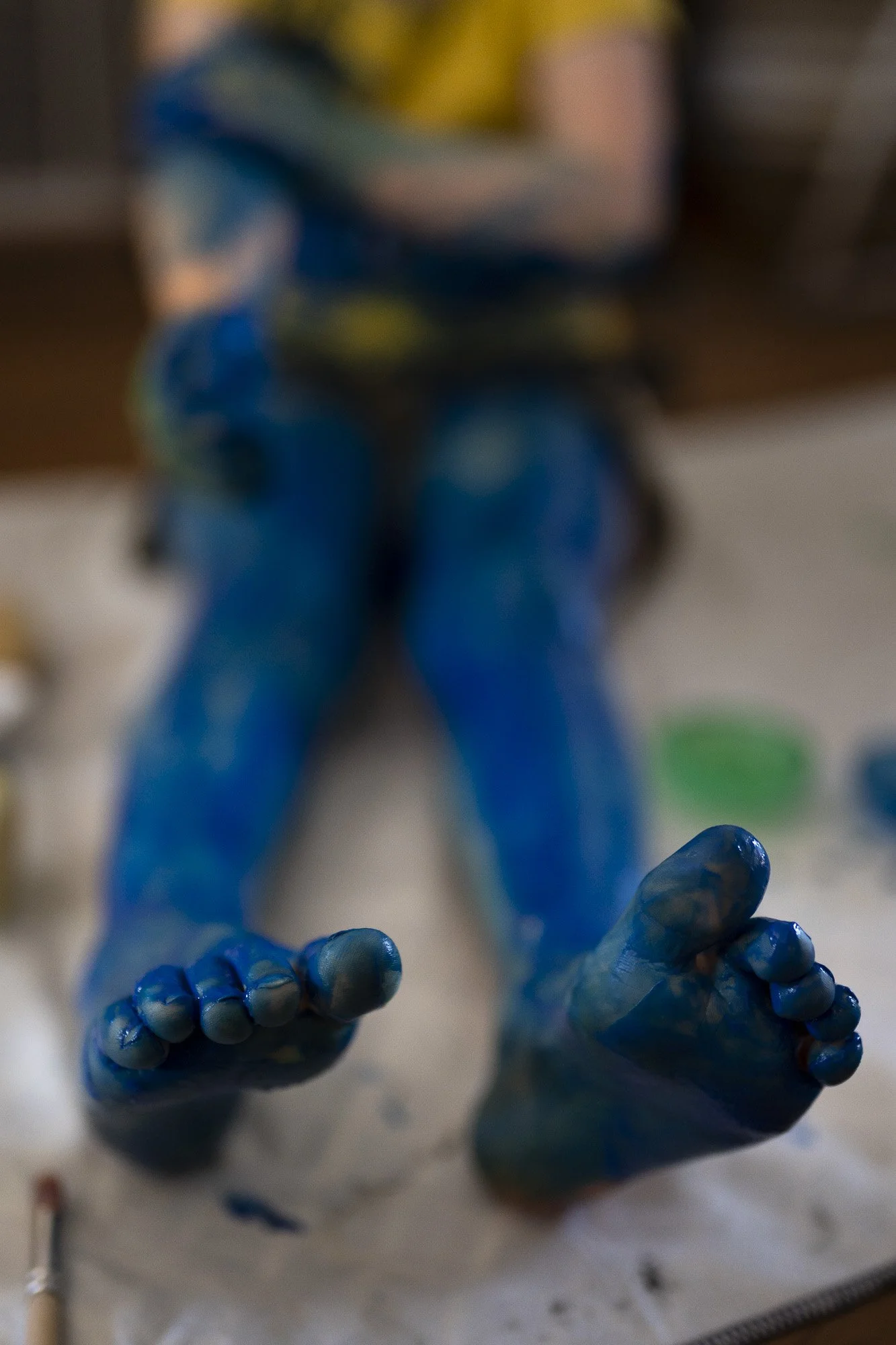 a child's legs that have been painted bright blue