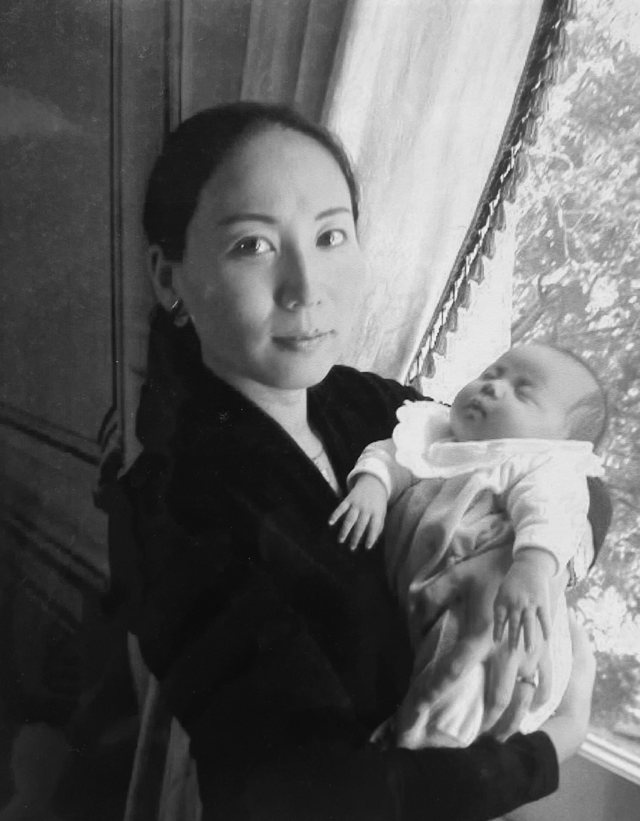 A mother holds her newborn in early motherhood — the beginning of a story. editorial family story photography capturing motherhood past and present. Noa Nguyen.