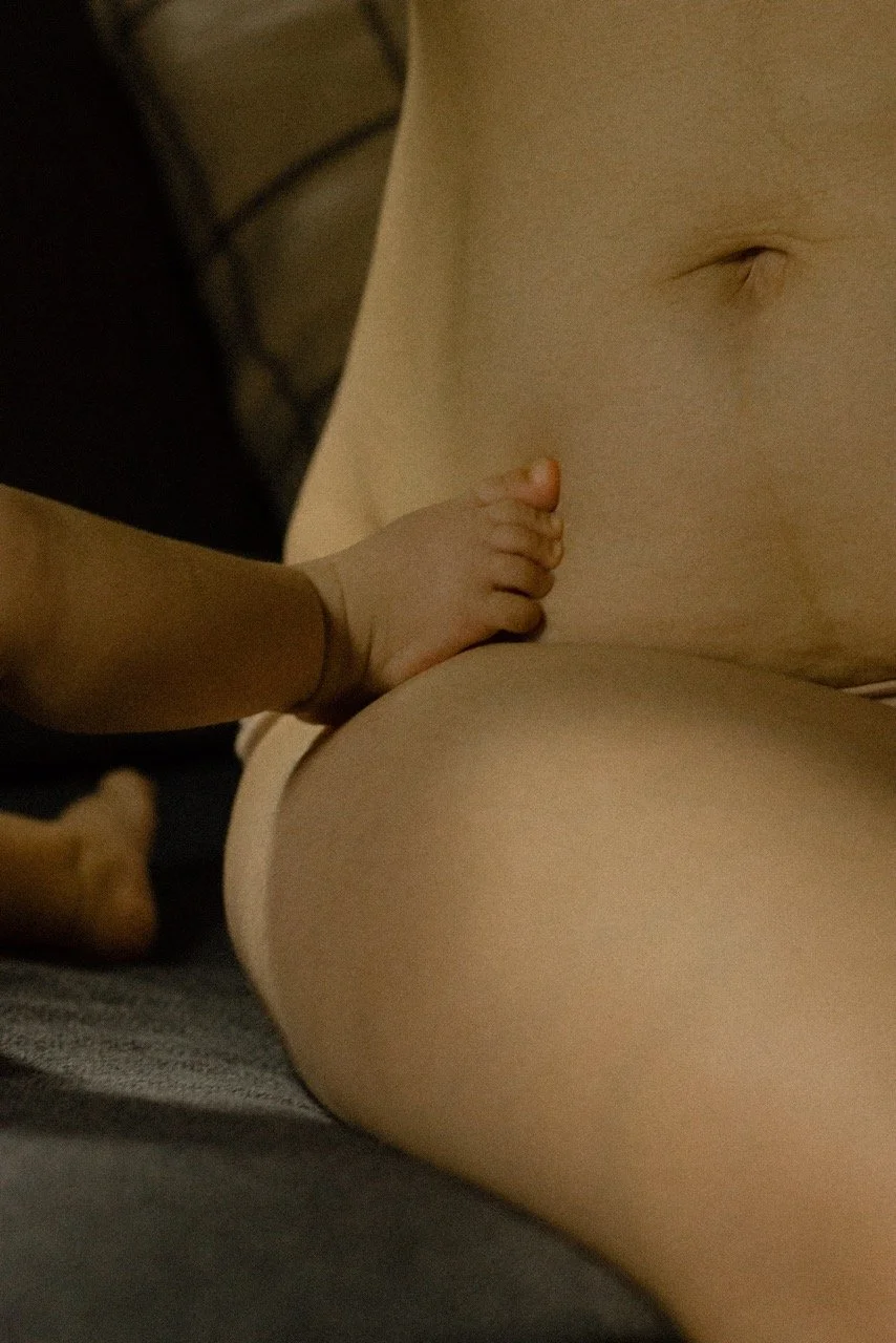 Baby feet touches mother bare skin — a quiet, tender detail capturing the emotional and physical intimacy of motherhood. motherhood , family life photography available in Tokyo, Saigon and Paris.