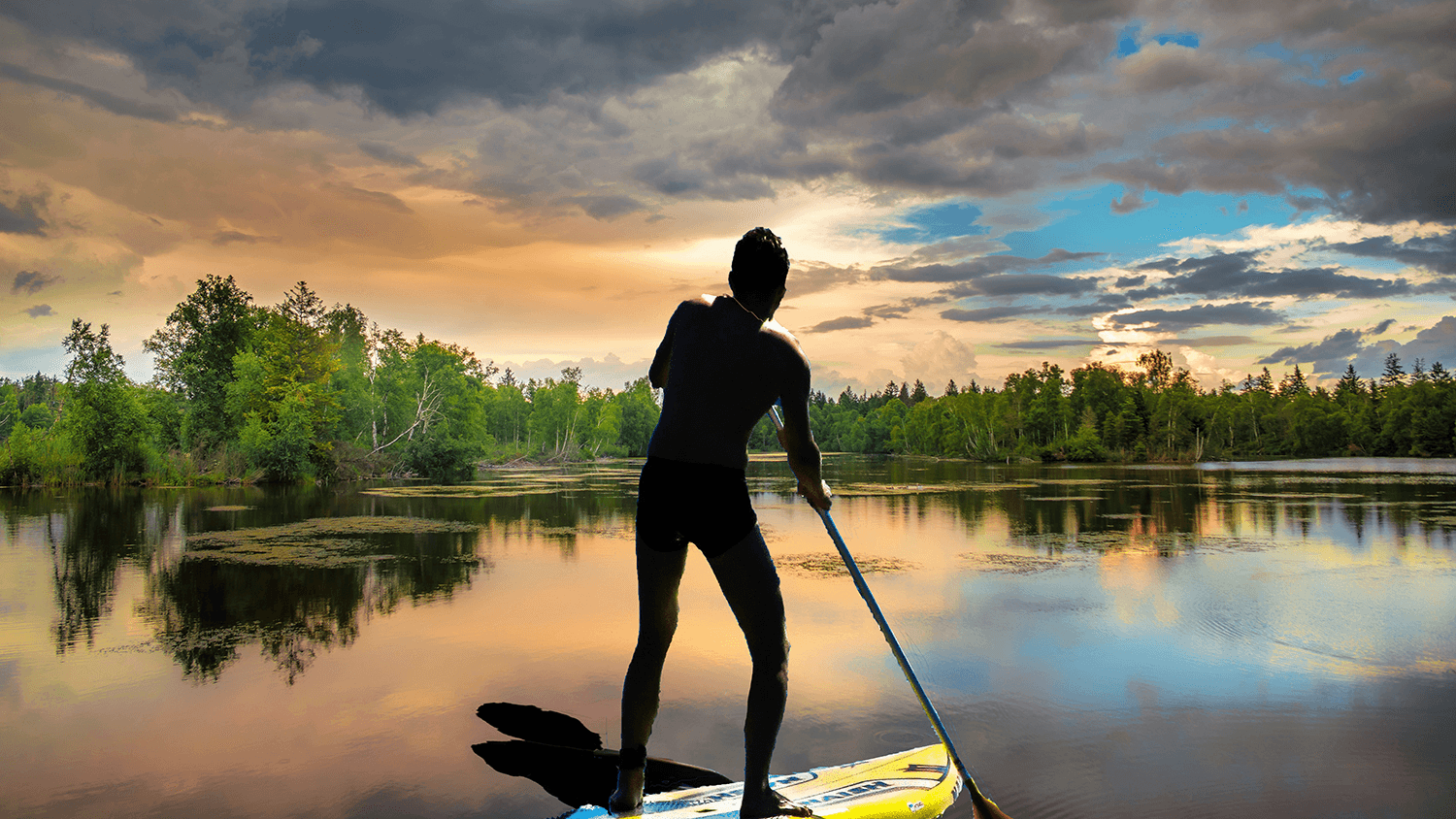 This is a composited image of a paddle boarder. I quick-selected the image of the paddle-boarder and transferred it to this image of a serene body of water. I then put a drop shadow to make the image appear a bit more realistic.