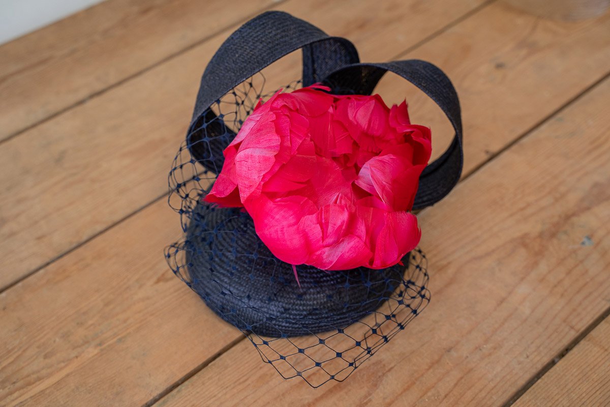 Navy fascinator with pink peony flower and navy netting