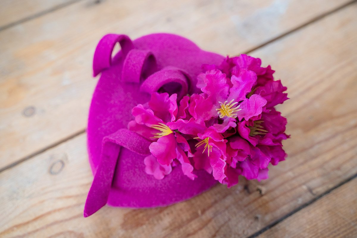 Bright fuchsia heart shape felt fascinator with handmade pink flowers