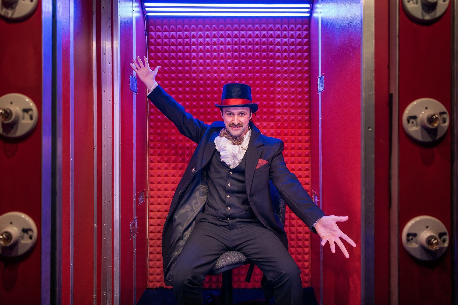 image of actor in magician costume with arms outstretched