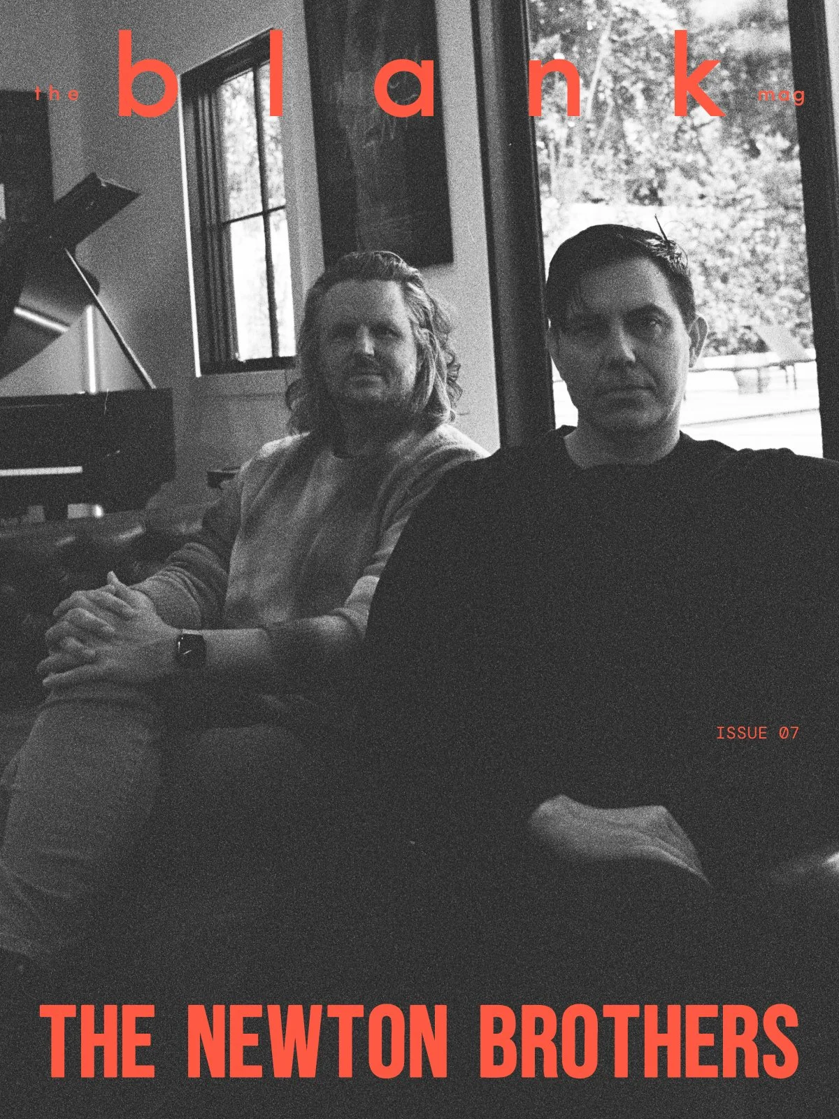 Black and white photo of two men sitting inside near a window, with text on the cover reading 'the blank mag,' 'ISSUE 07,' and 'THE NEWTON BROTHERS' in red font.