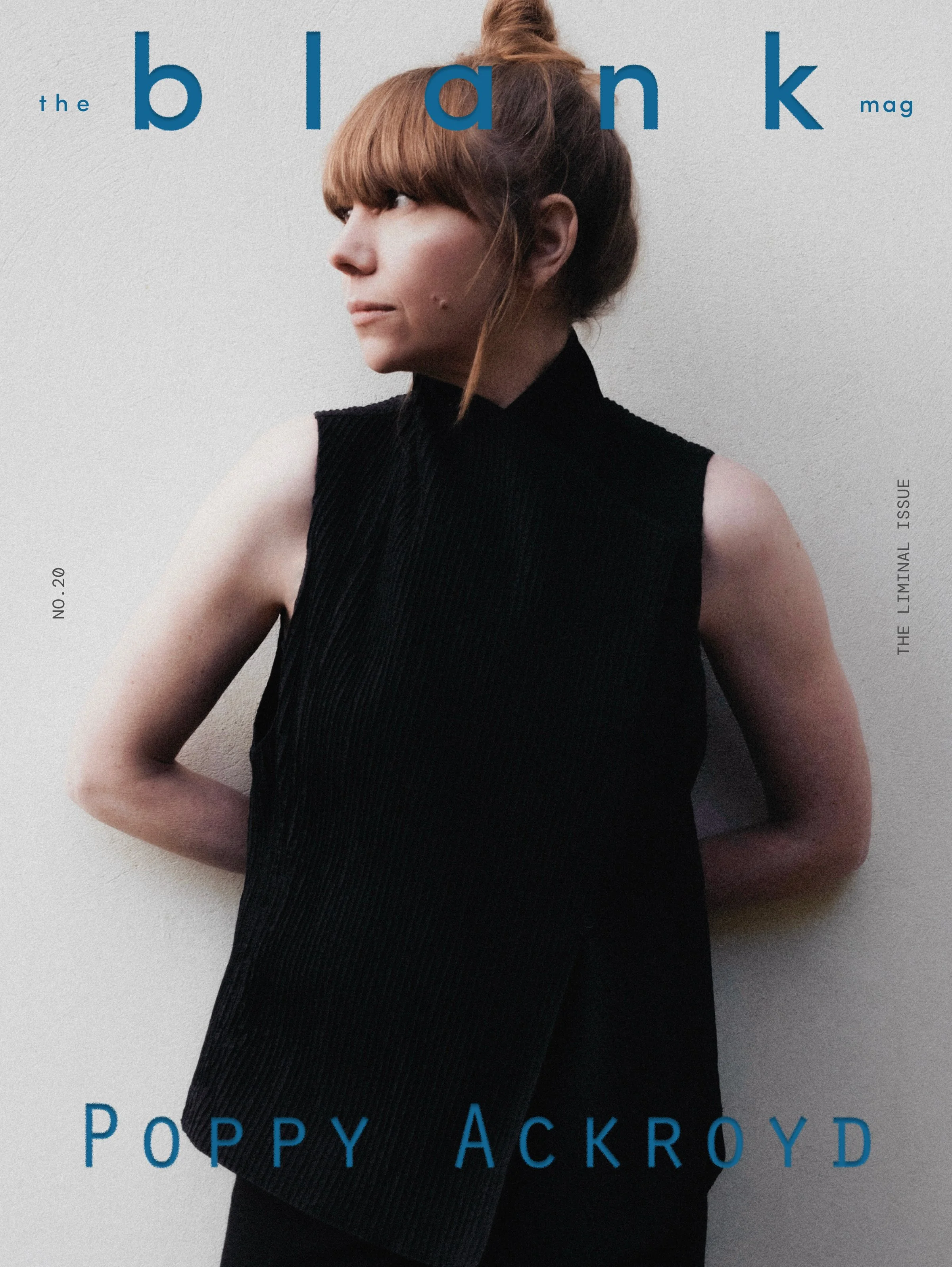 The image is a magazine cover featuring a woman with red hair tied up in a bun wearing a sleeveless black top, with text overlays including the word 'the' in small blue font, the word 'blank' in large blue font, and the words 'the ultimate issue' in small vertical gray font. The title of the magazine is 'POPPI ACKROYD' in large blue font at the bottom.