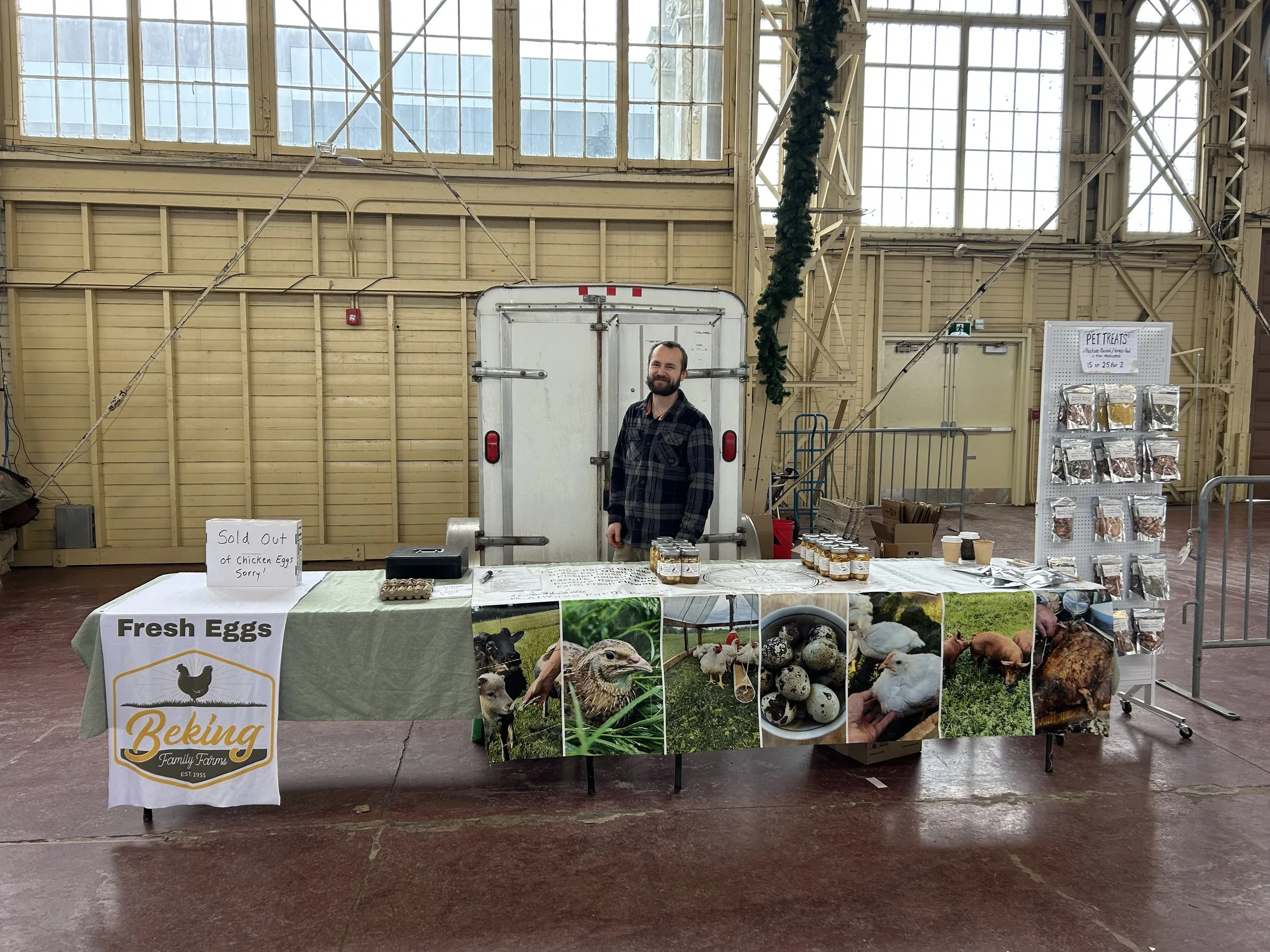 Sun Dynasty Farm vendor standing at the Landsdowne Farmers Market selling quail eggs