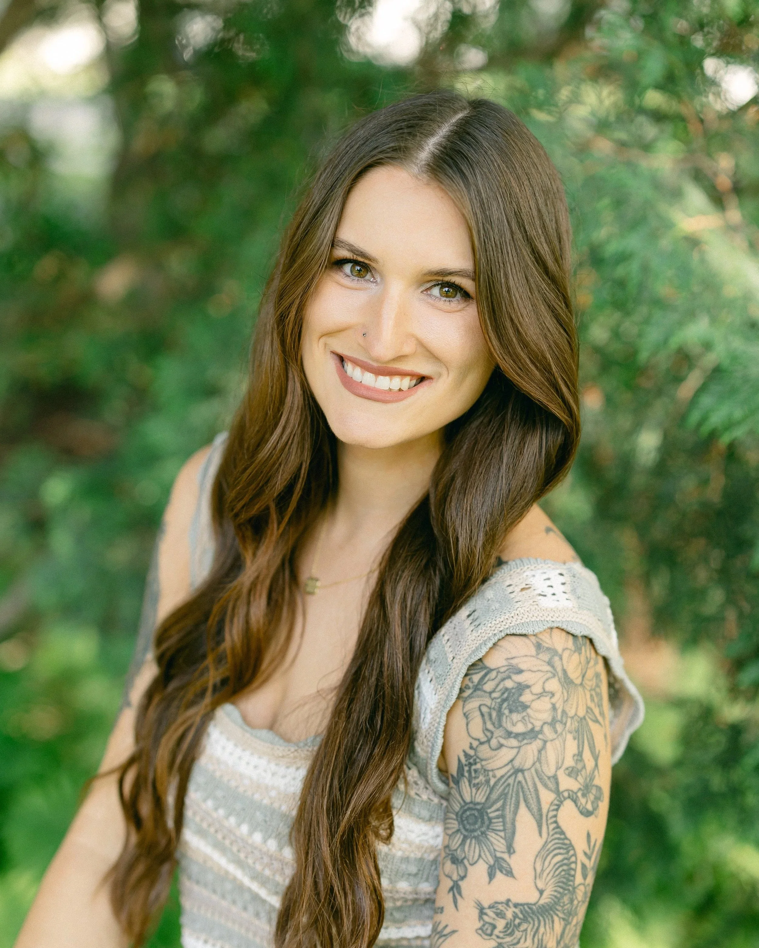 Jessica Nelson smiling while sitting on a brown leather chair