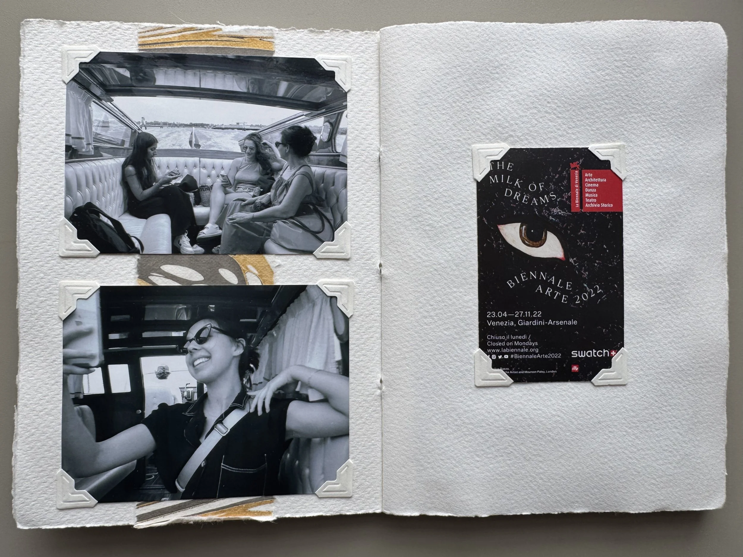 An open photo album with two black and white photos on the left side and a promotional card on the right side. The top left photo shows three women sitting inside a boat, looking at their phones. The bottom left photo shows a woman smiling and sittin