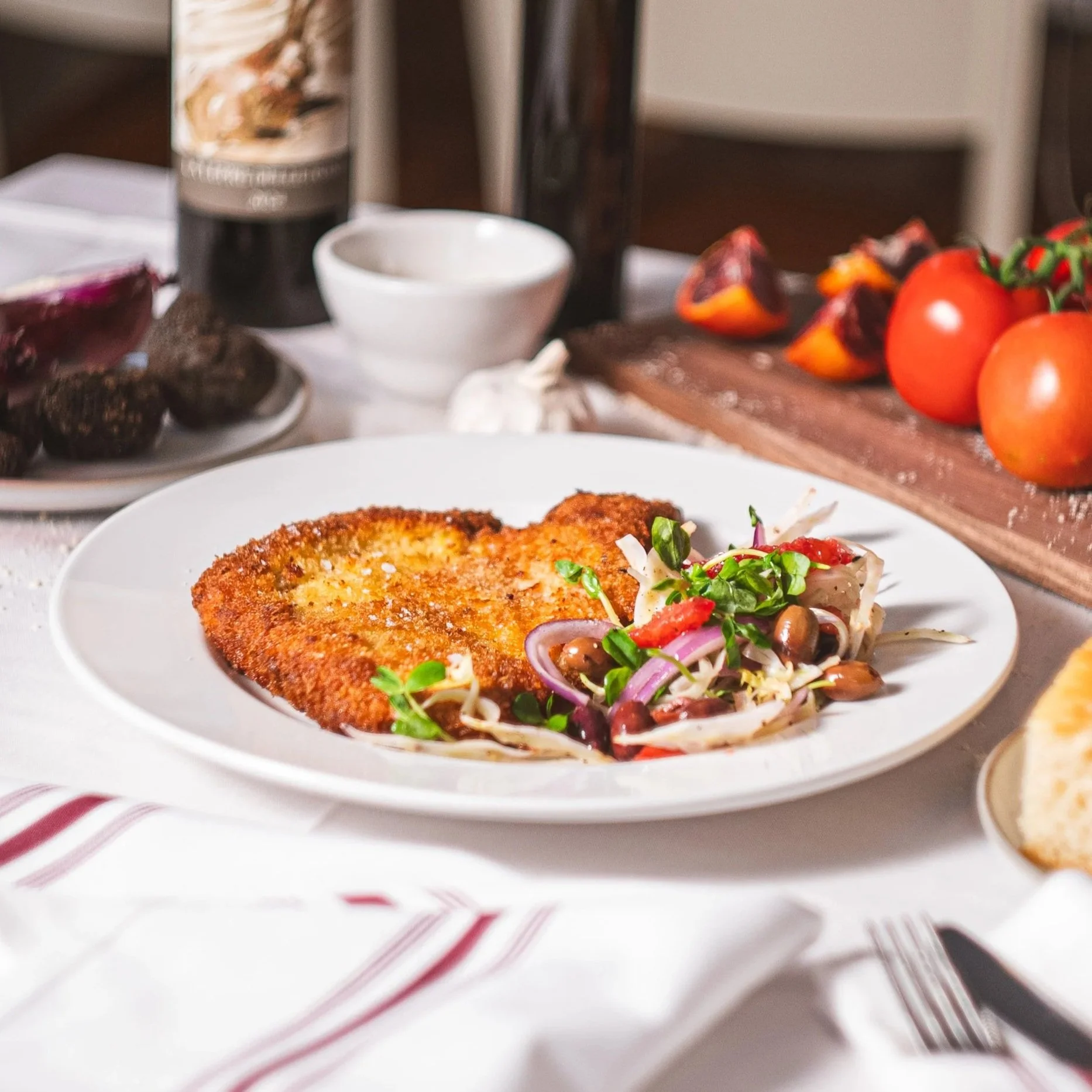 Breaded and fried pork chop, served with blood orange, fennel, red onion leccino olives
