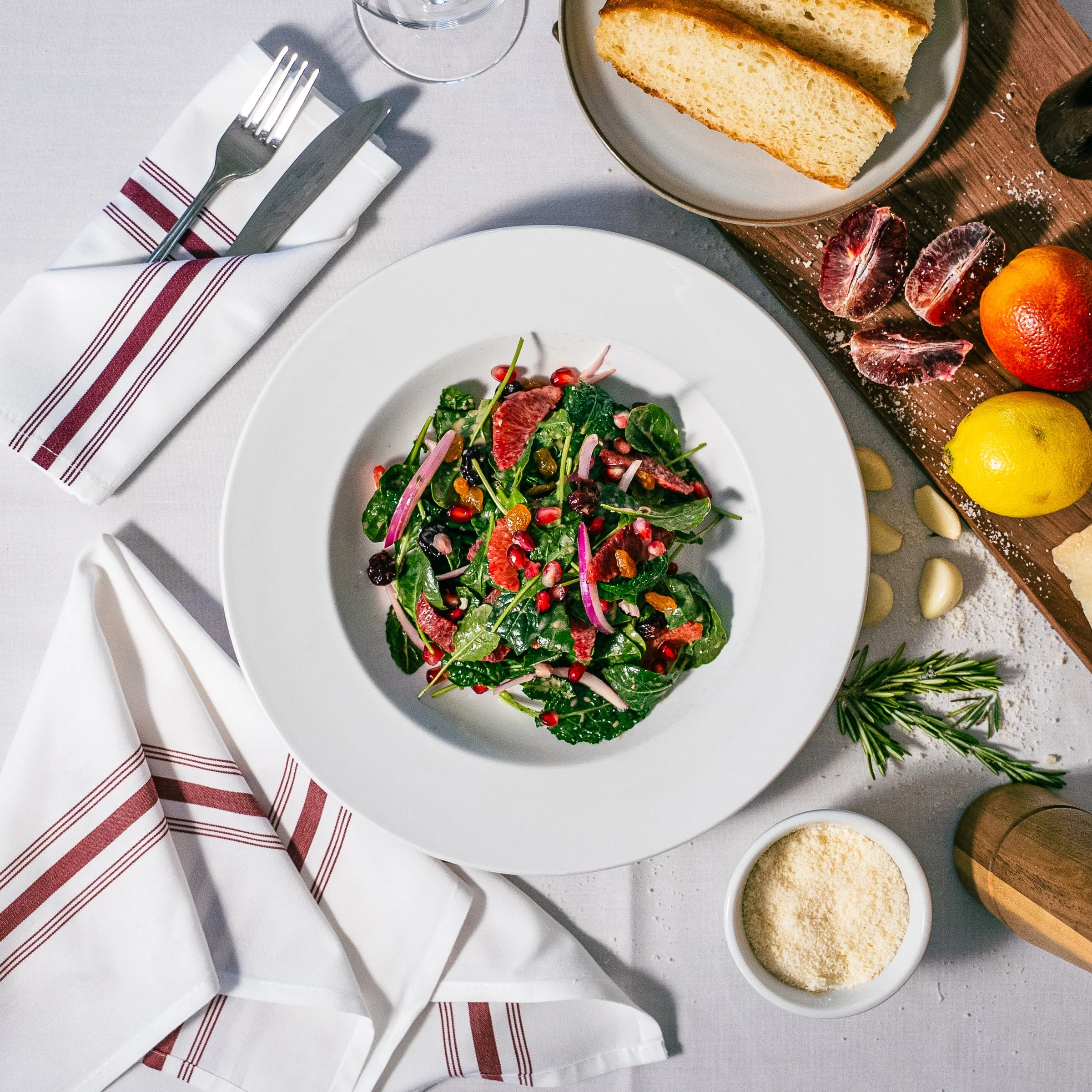 Baby kale, red onion, Blood orange,  maple  Mustard vinaigrette, pomegranate, dried cranberries, golden raisins. 
