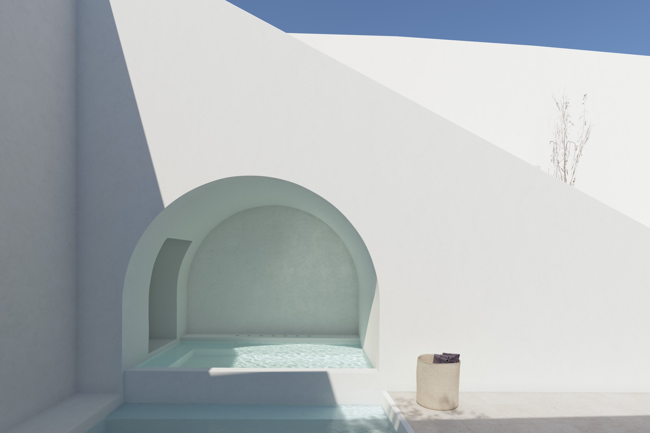 Estructura moderna blanca con un arco, una piscina de agua clara y un cesto con ropa encima, bajo un cielo azul