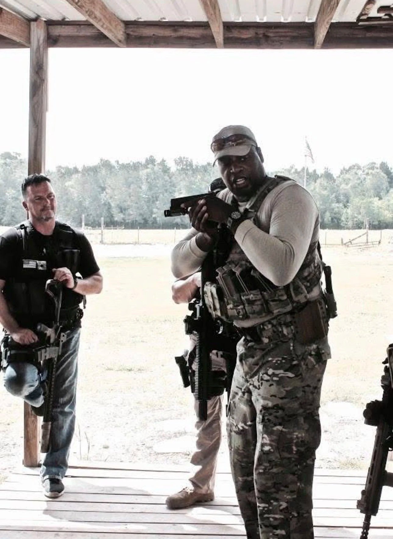 Instructor teaching handling of pistol
