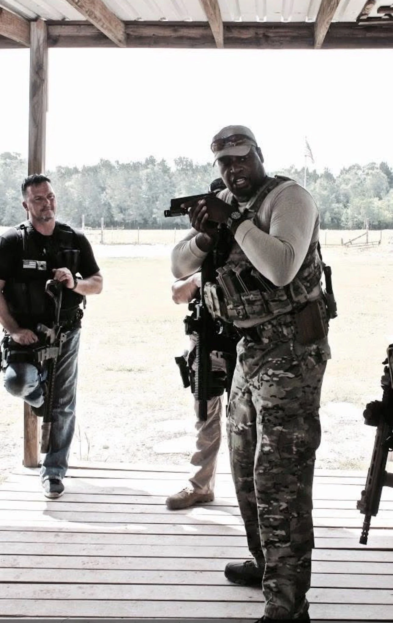 Instructor teaching handling of pistol