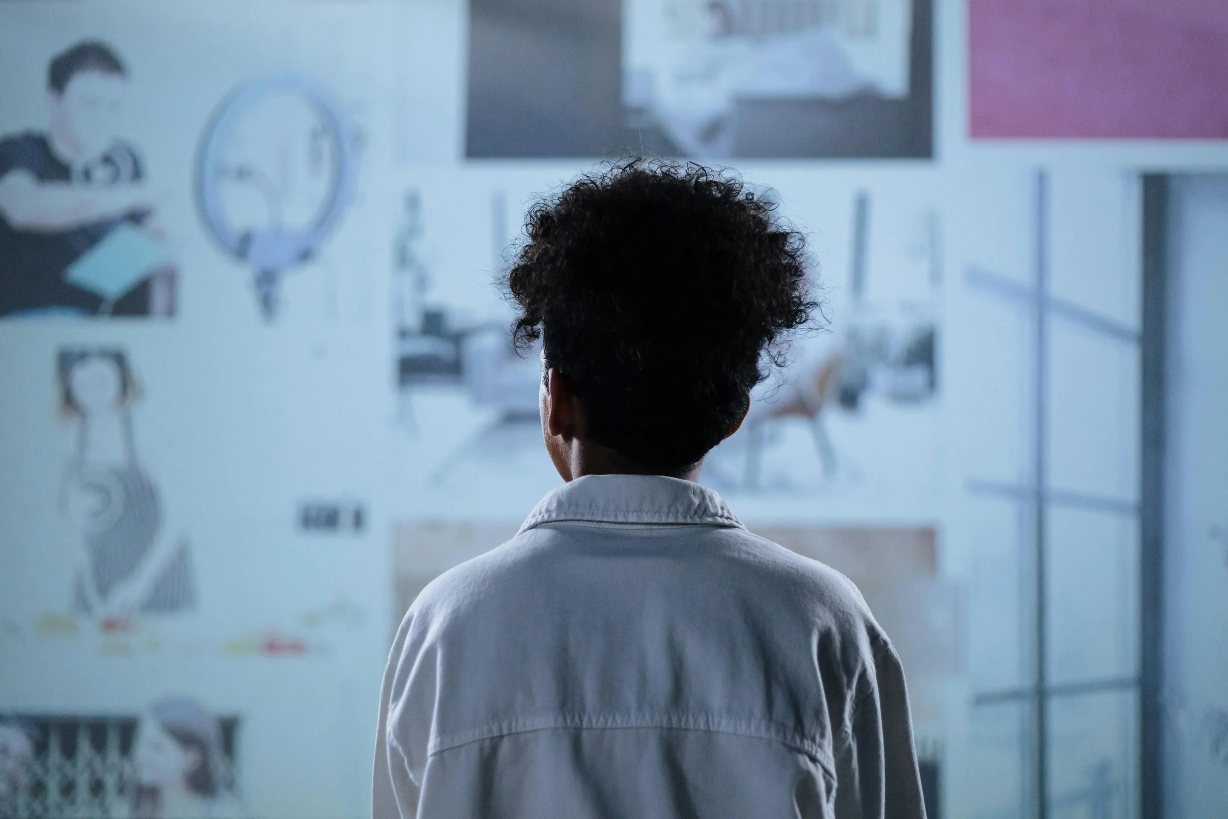 Black woman looking at art on a wall