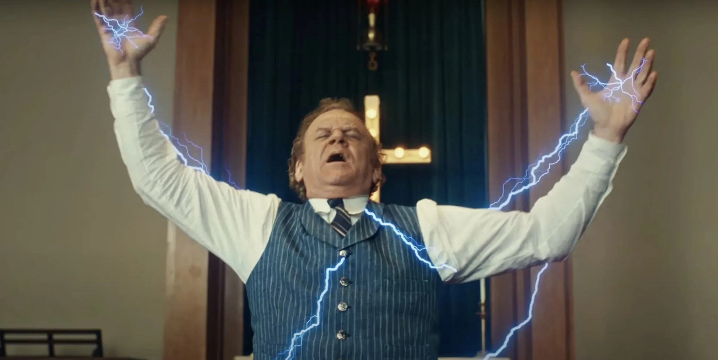 A man dressed as a preacher or minister with arms raised and eyes closed, surrounded by animated lightning bolts, in front of a church or religious setting.