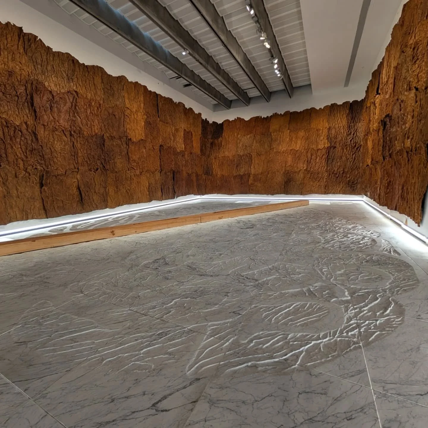 I really loved this installation. Not just because you have to walk on the textured marble on bare feet, but also the smell of leather and wood and instantly understanding the life in the materials. 

A super simple wall tag text doesn't hurt either.