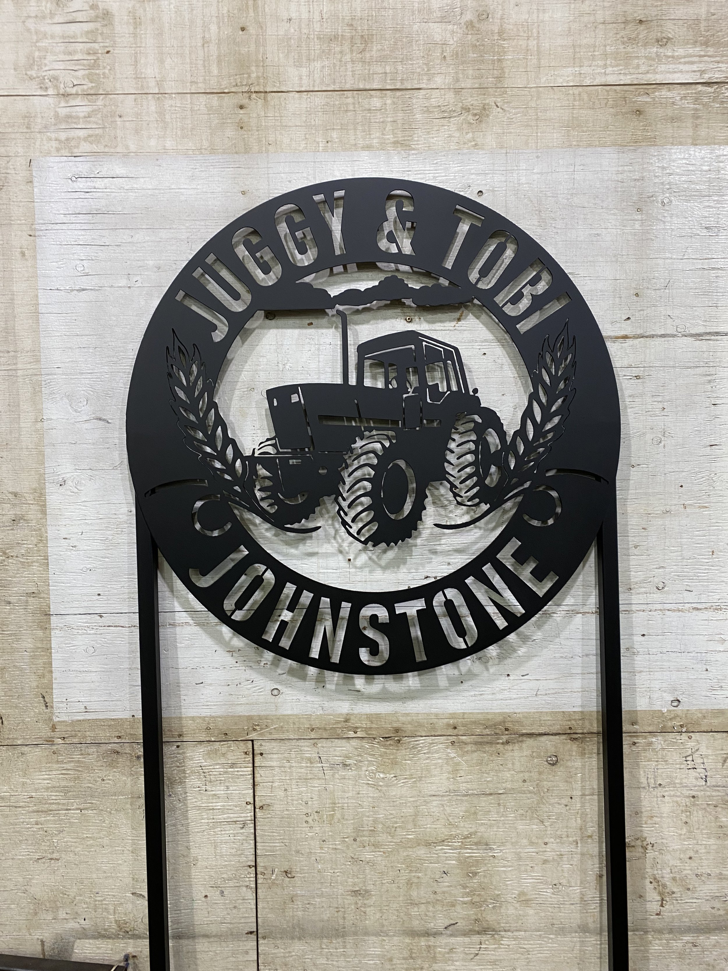 A decorative personalized laser-cut metal sign for family home, handmade in Saskatchewan
