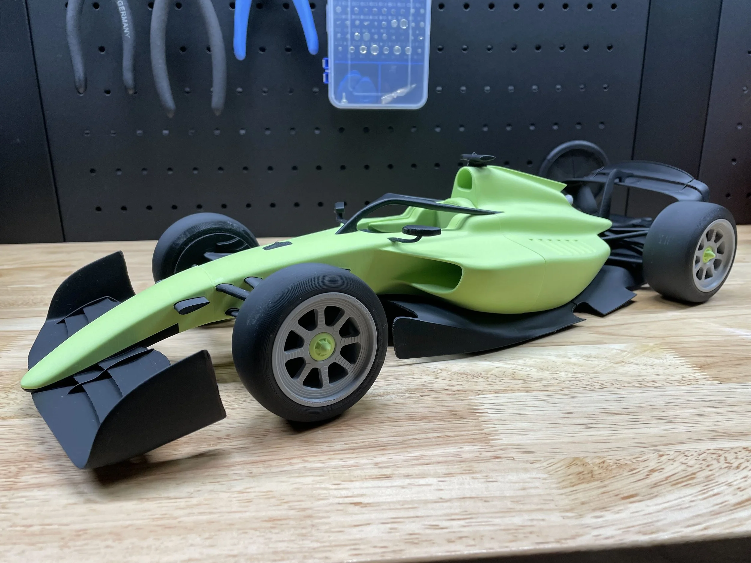 A green and black 3D-printed F2 style openwheeler racecar