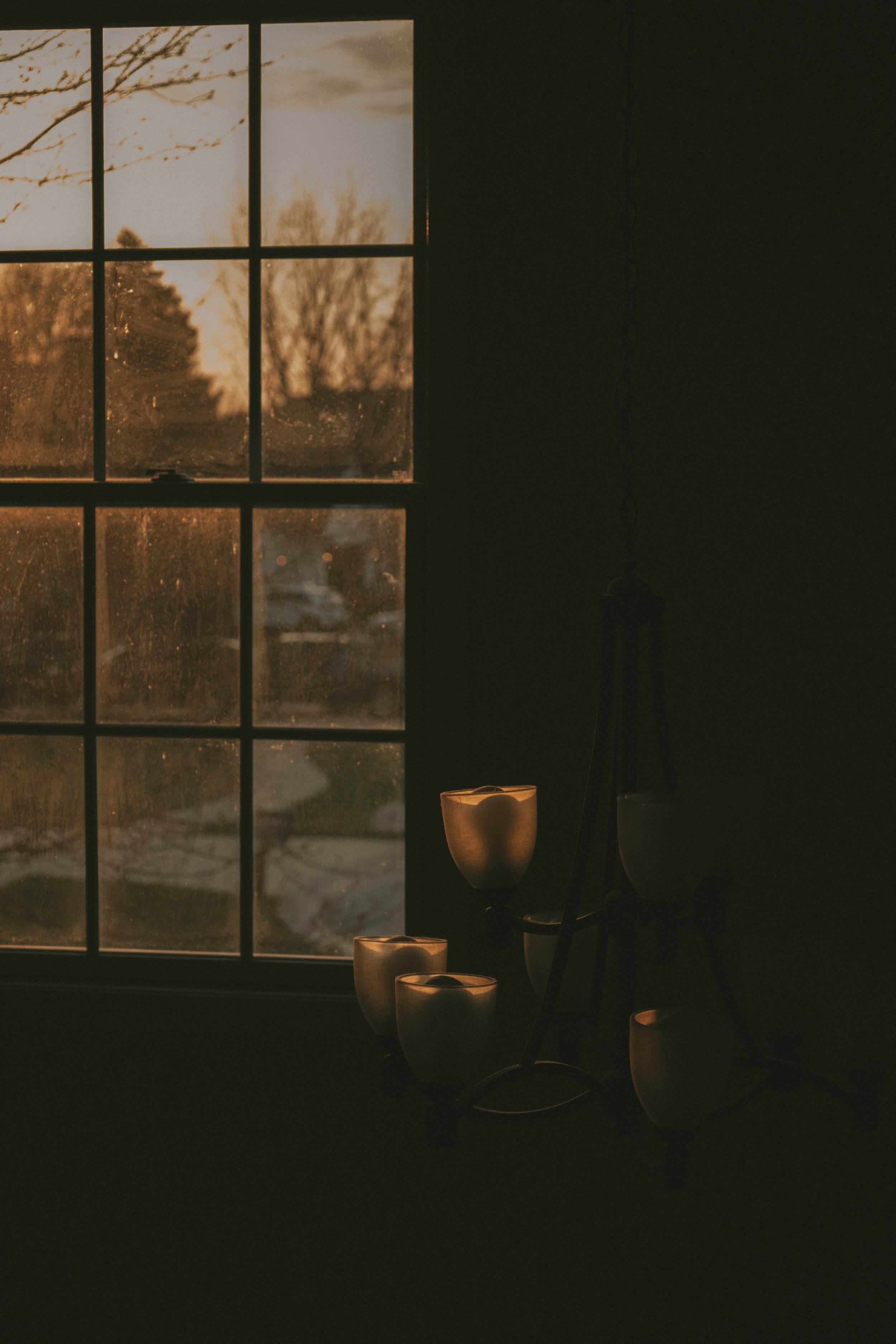 Quiet sunlit window with candles, representing a simple and grounded way of connecting with Spirit through presence