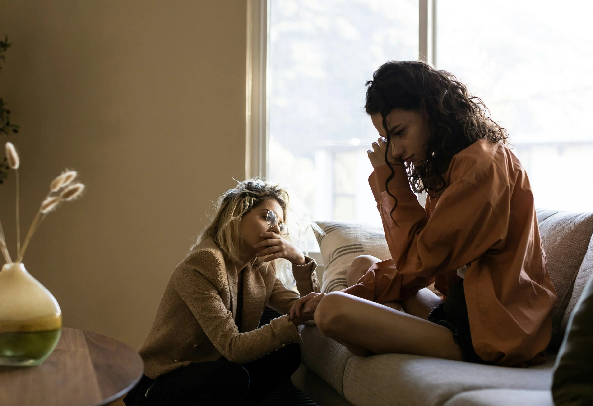 Two women navigating an emotional relationship conflict, illustrating nervous system activation, emotional overwhelm, and the need for somatic regulation in therapy