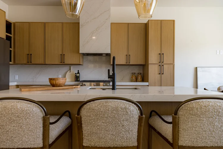 Finished kitchen with white oak cabinetry and quartz island