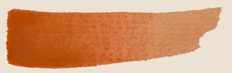 Swatch of orange-colored makeup or paint on textured paper
